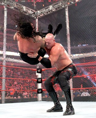 Kane chokeslams the Undertaker, photo copyright to WWE.com