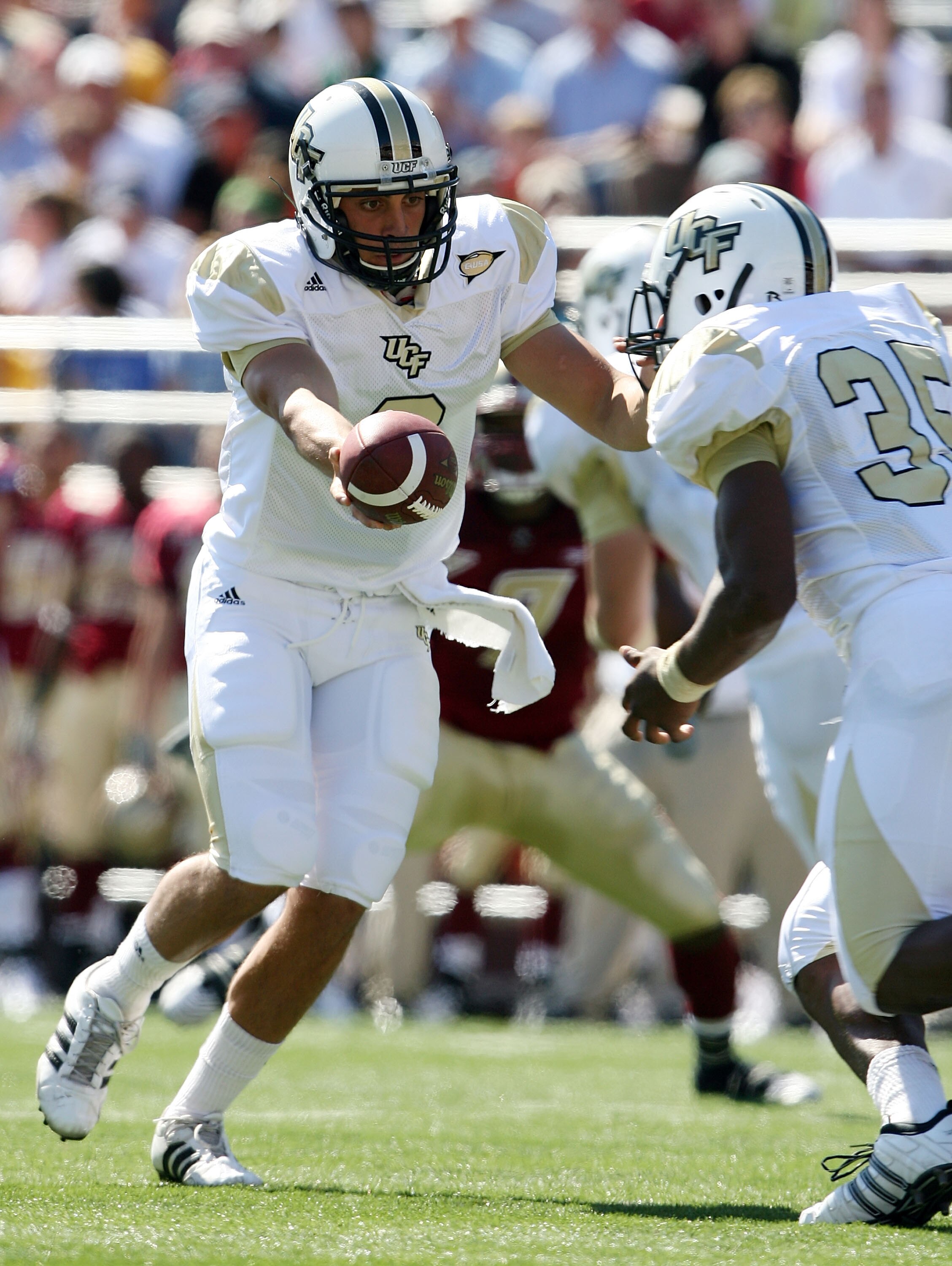 CHESTNUT HILL, MA - SEPTEMBER 20:  Michael Greco #2 of the Central Florida Knights hands the ball off to Ronnie Weaver #35 in the first half against the Boston College Eagles on September 20, 2008 at Alumni Stadium in Chestnut Hill, Massachusetts.  (Photo