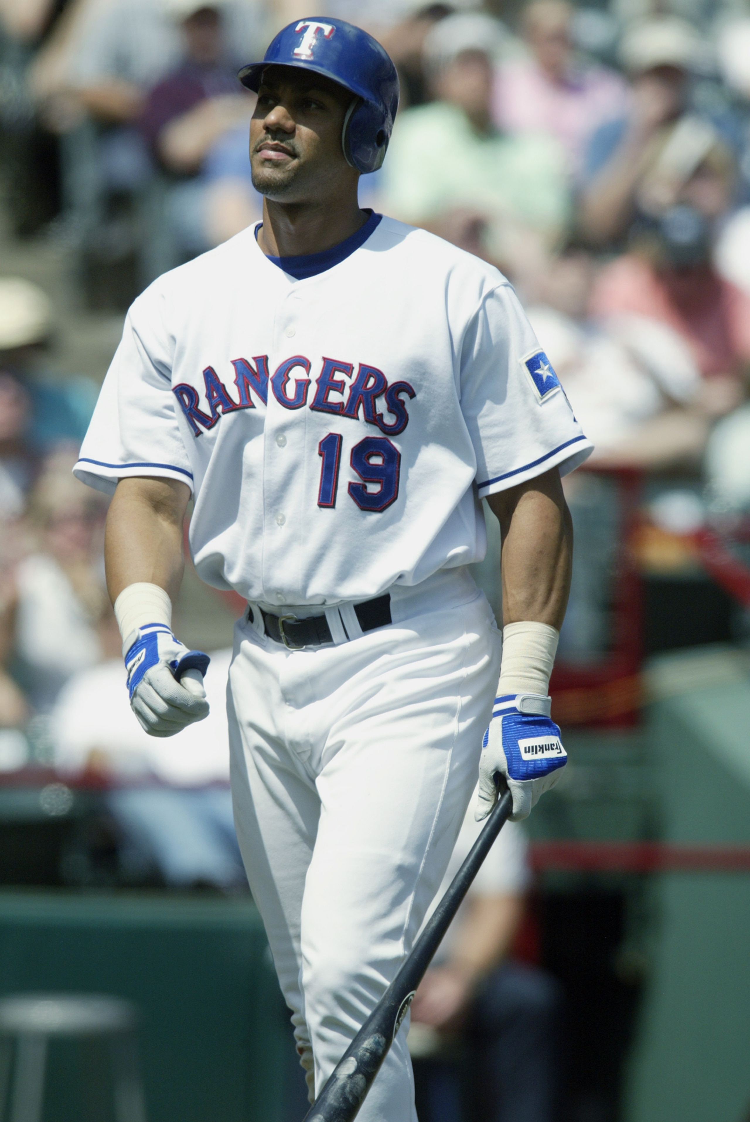 ARLINGTON, TX - MAY 11: Juan Gonzalez #19 of the Texas Rangers walks back to the dugout after an at bat during the game against the Cleveland Indians at the Ballpark in Arlington on May 11, 2003 in Arlington, Texas. The Rangers defeated the Indians 17-1 ARLINGTON, TX - MAY 11: Juan Gonzalez #19 of the Texas Rangers walks back to the dugout after an at bat during the game against the Cleveland Indians at the Ballpark in Arlington on May 11, 2003 in Arlington, Texas. The Rangers defeated the Indians 17-1