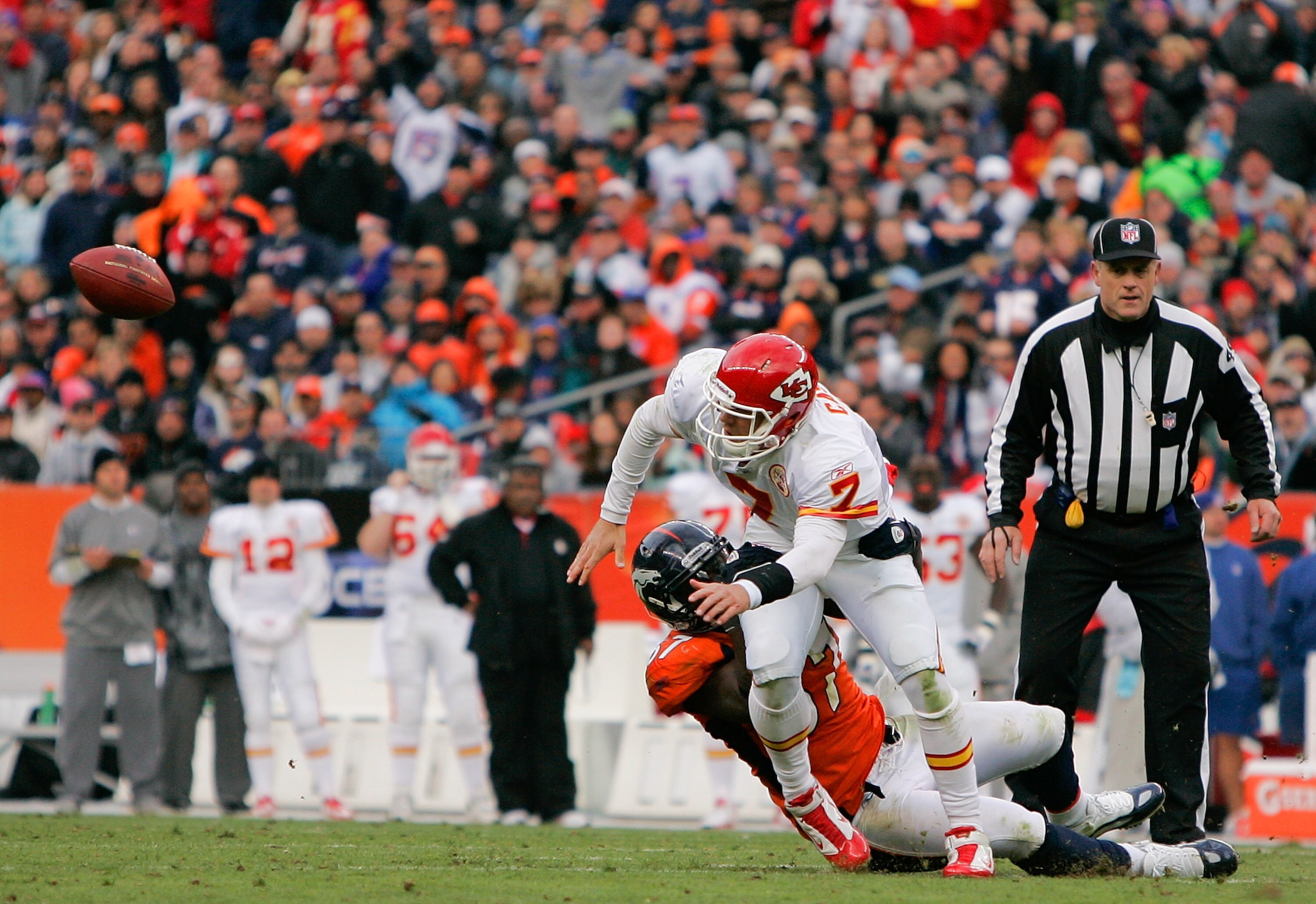 DENVER - NOVEMBER 14:  Quarterback Matt Cassel #7 of the Kansas City Chiefs fumbles the ball while being tackled by linebacker Mario Haggan #57 of the Denver Broncos during the second quarter at INVESCO Field at Mile High on November 14, 2010 in Denver, C