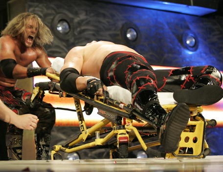 Edge defeating Kane in a stretcher match, photo copyright to WWE.com