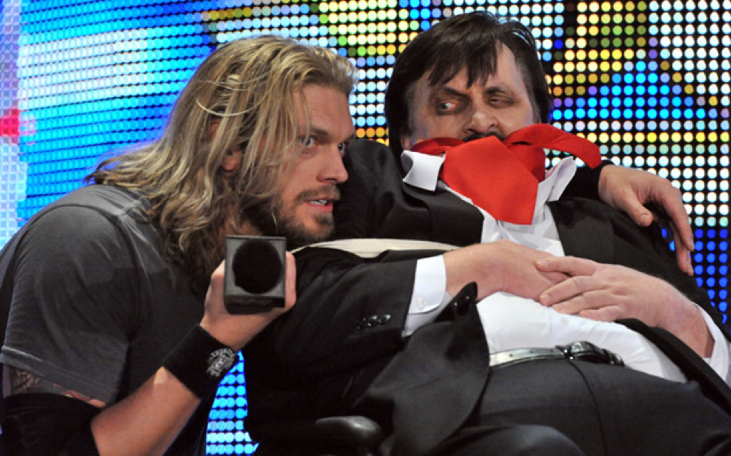 Edge holding Paul Bearer "hostage," photo copyright to WWE.com