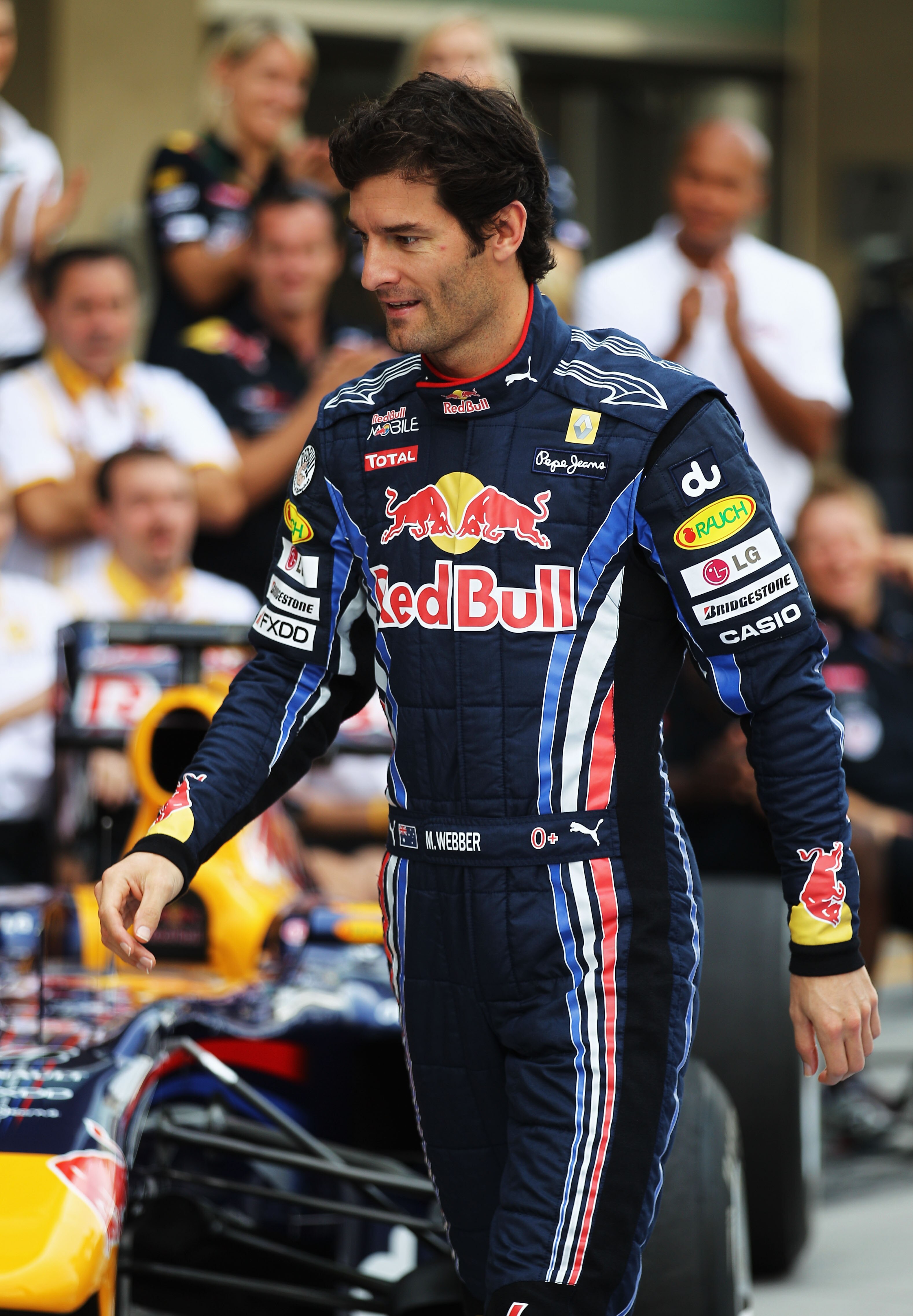 ABU DHABI, UNITED ARAB EMIRATES - NOVEMBER 14:  Mark Webber of Australia and Red Bull Racing arrives for his team end of season team photograph before the Abu Dhabi Formula One Grand Prix at the Yas Marina Circuit on November 14, 2010 in Abu Dhabi, United