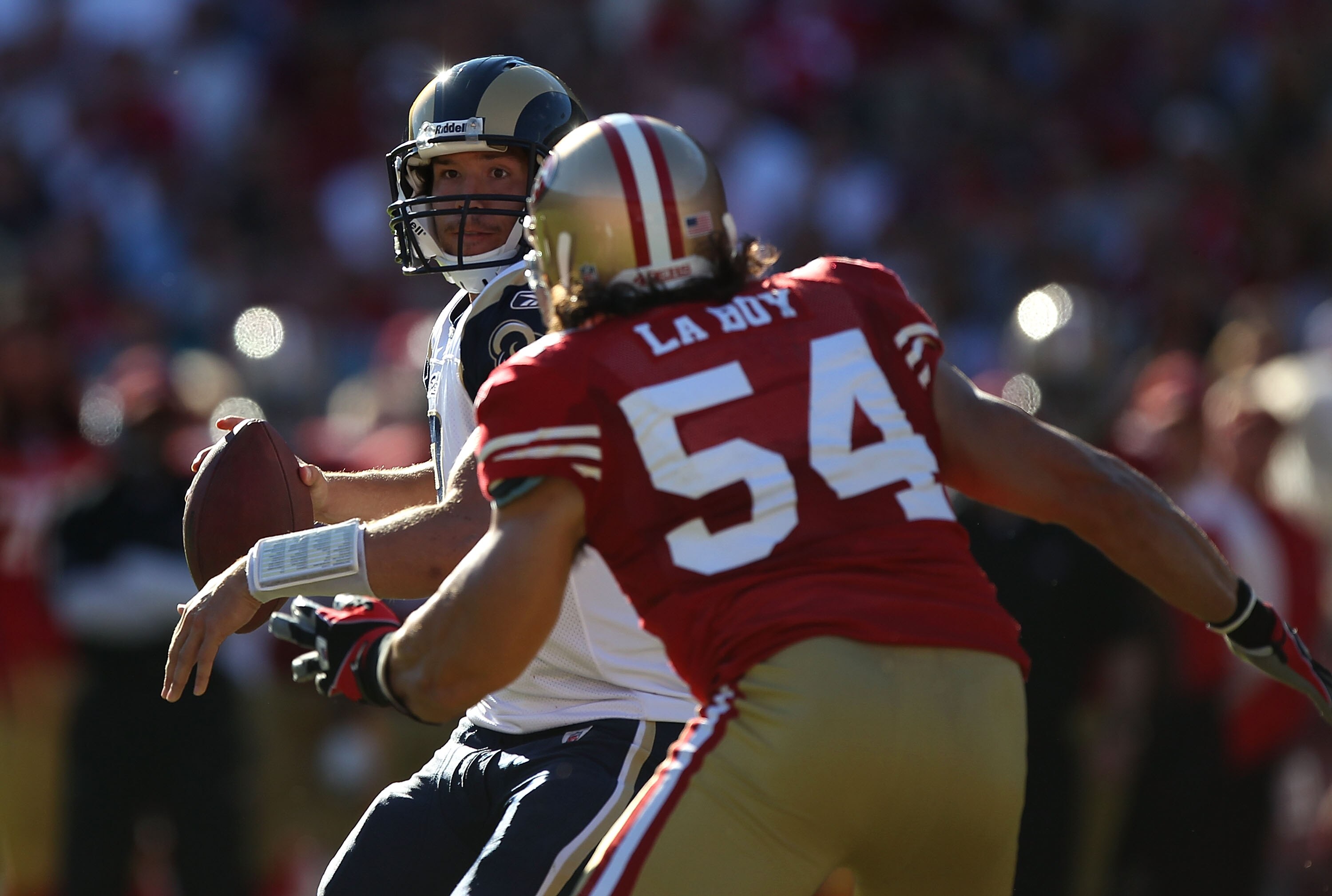 SAN FRANCISCO - NOVEMBER 14:  Sam Bradford #8 of the St. Louis Rams passes against Travis LaBoy #54 of the San Francisco 49ers during an NFL game at Candlestick Park on November 14, 2010 in San Francisco, California.(Photo by Jed Jacobsohn/Getty Images)