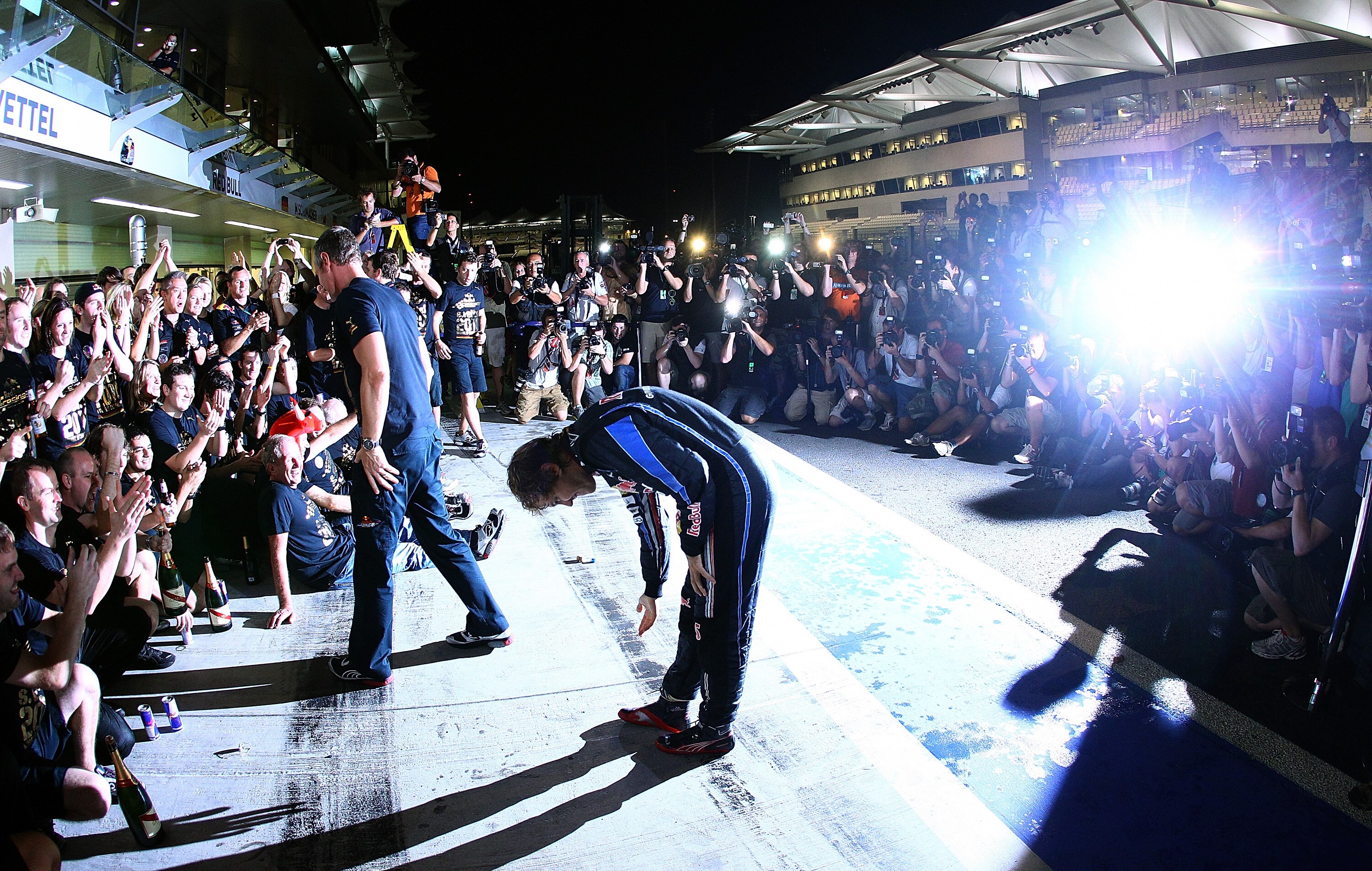 ABU DHABI, UNITED ARAB EMIRATES - NOVEMBER 14:  Sebastian Vettel of Germany and Red Bull Racing gives a bow to his team after the Abu Dhabi Formula One Grand Prix at the Yas Marina Circuit on November 14, 2010 in Abu Dhabi, United Arab Emirates.  (Photo b