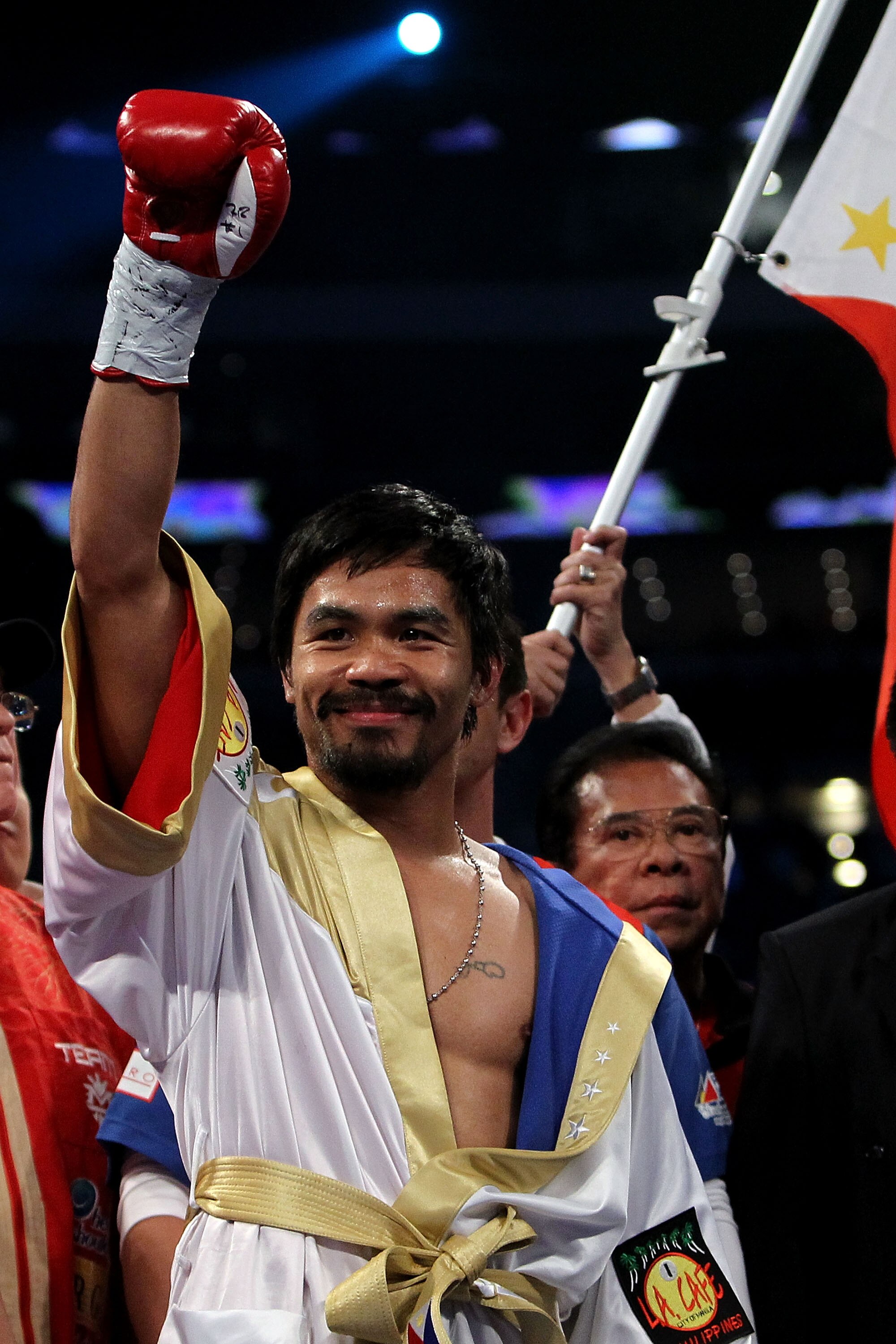 ARLINGTON, TX - NOVEMBER 13:  Manny Pacquiao (white trunks) of the Philippines raises his hand in the air as he stands in the ring waiting to fight against Antonio Margarito (black trunks) of Mexico during their WBC World Super Welterweight Title bout at