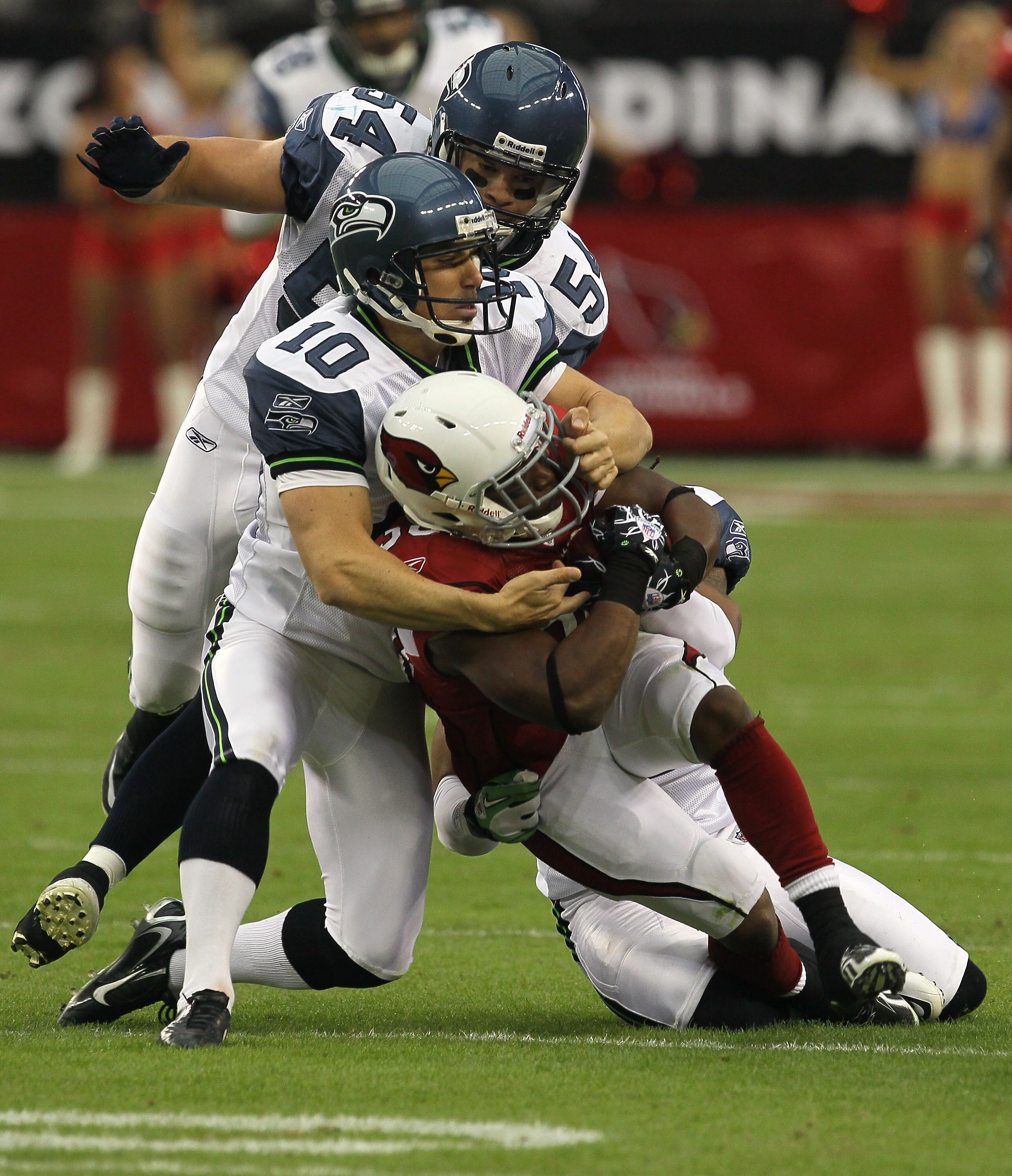 GLENDALE, AZ - NOVEMBER 14:  Kicker Olindo Mare #10 of the Seattle Seahawks tackles returner LaRod Stephens-Howling #36 of the Arizona Cardinals on the opening kickoff at University of Phoenix Stadium on November 14, 2010 in Glendale, Arizona. Seattle won