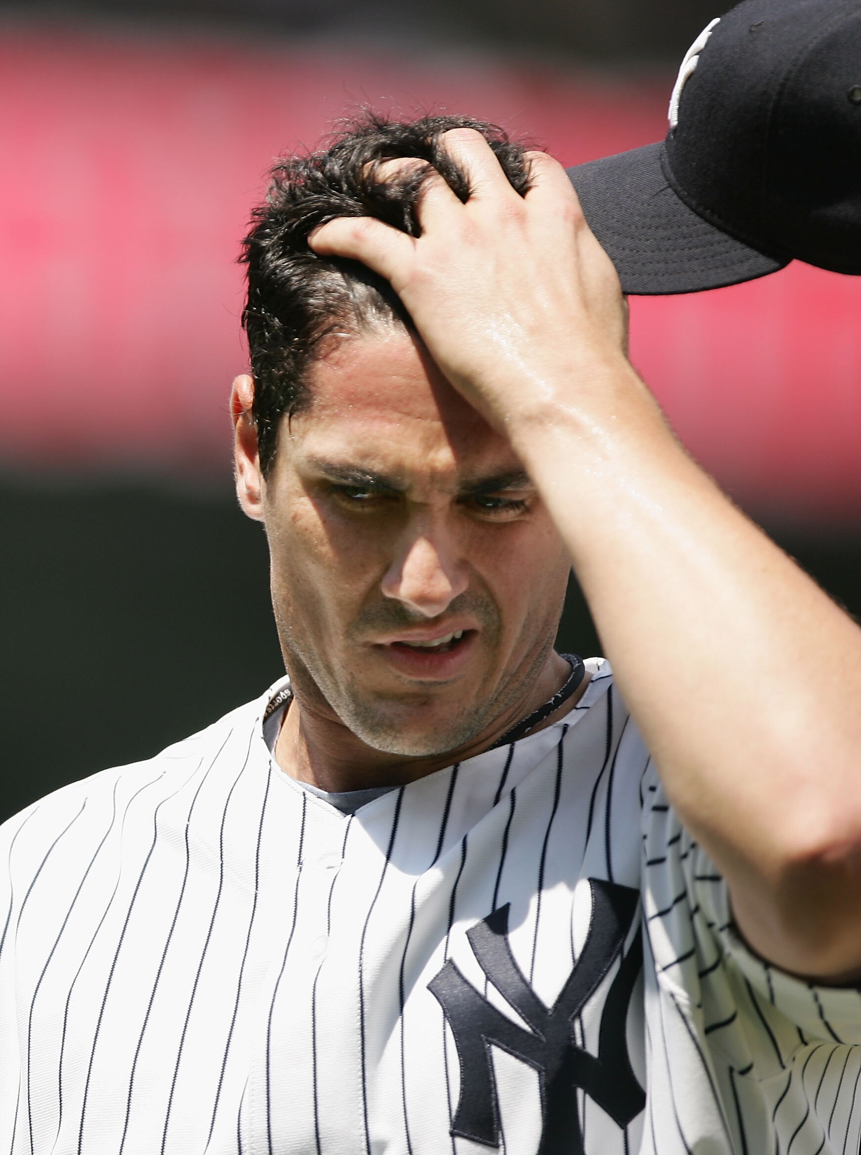 NEW YORK - June 22: Carl Pavano #45 of the New York Yankees walks back to the dugout at the end of the fourth inning after giving up a home run to Jonny Gomes of the Tampa Bay Devil Rays during their game June 22, 2005 at Yankee Stadium in the Bronx borou
