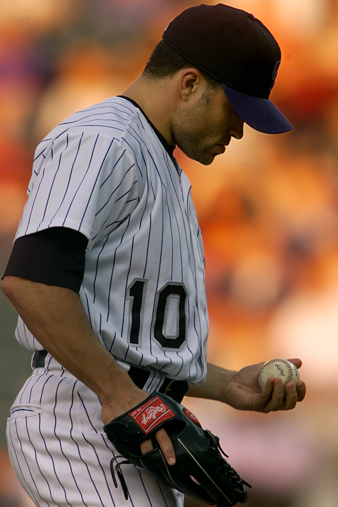 15 Aug 2001:  Starting pitcher Mike Hampton #10 of the Colorado Rockies checks the ball as he walks onto the mound against the Atlanta Braves at Coors Field in Denver, Colorado. Hampton gave up six runs on a grand slam and a home run.  DIGITAL IMAGE Manda