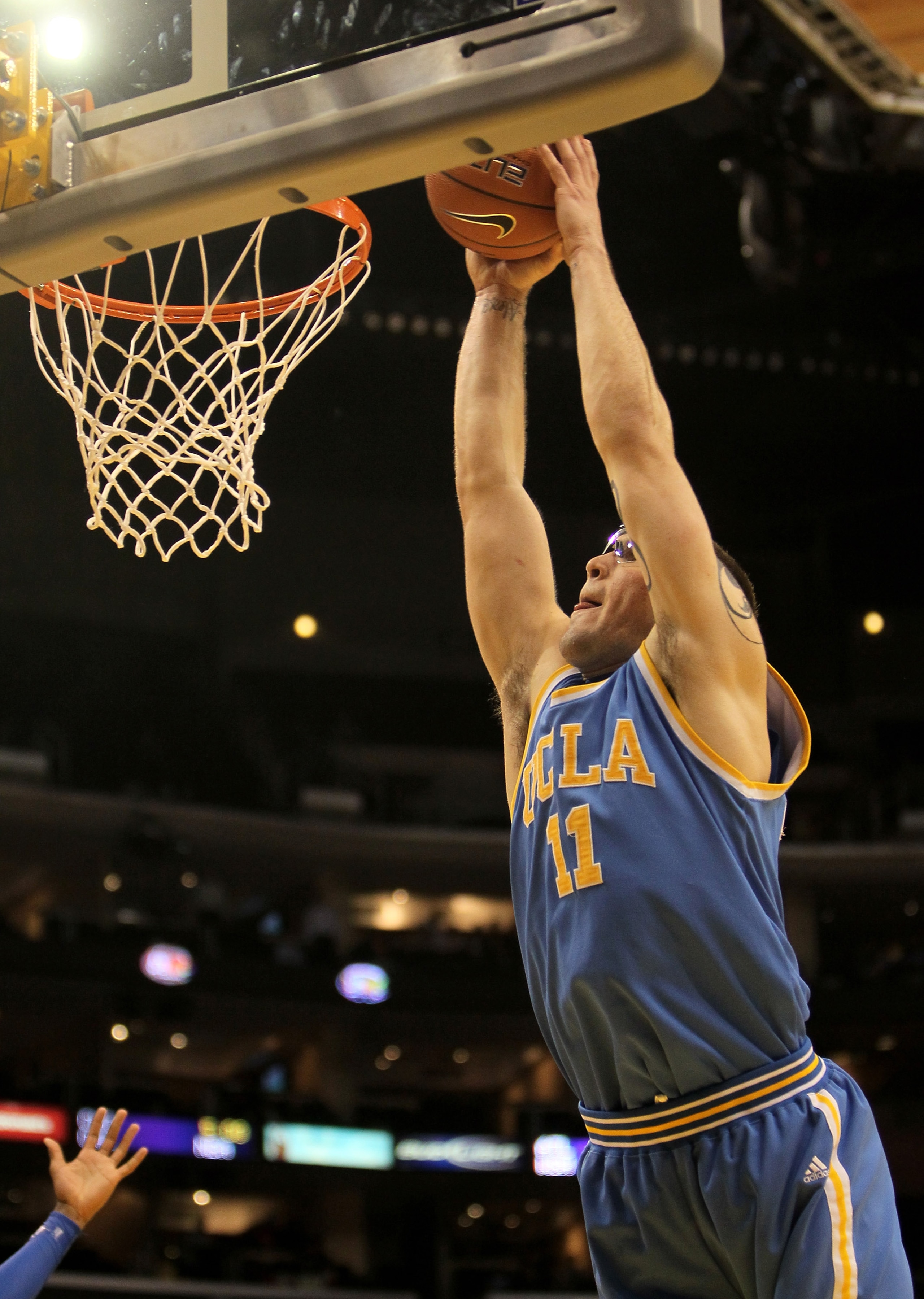 LOS ANGELES, CA - MARCH 11:  Reeves Nelson #11 of the UCLA Bruins goes in for a dunk against the Arizona Wildcats during the quarterfinals of the Pac-10 Basketball Tournament at Staples Center on March 11, 2010 in Los Angeles, California. UCLA won 75-69.