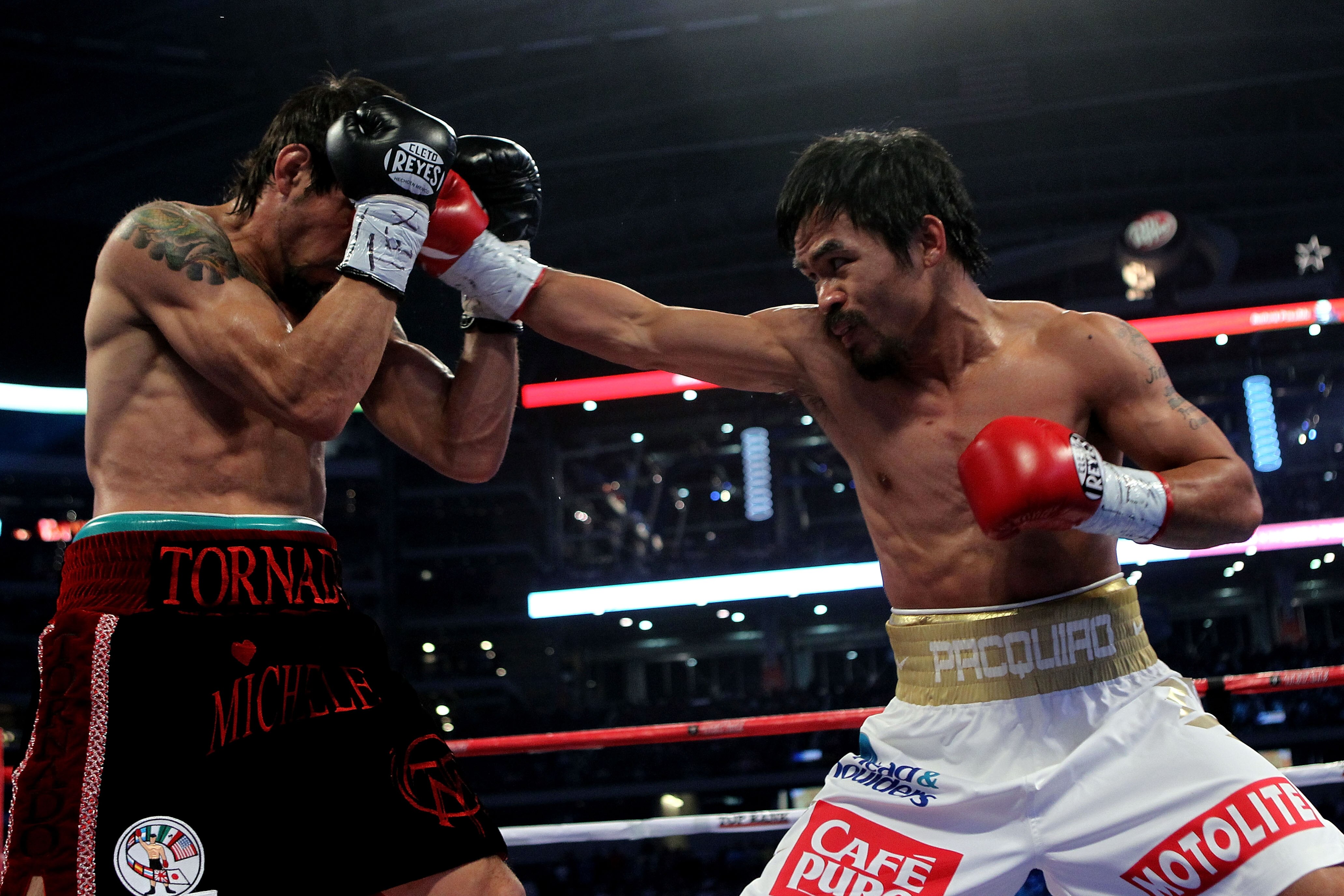ARLINGTON, TX - NOVEMBER 13:  Manny Pacquiao (white trunks) of the Philippines lands a punch against Antonio Margarito (black trunks) of Mexico during their WBC World Super Welterweight Title bout at Cowboys Stadium on November 13, 2010 in Arlington, Texa