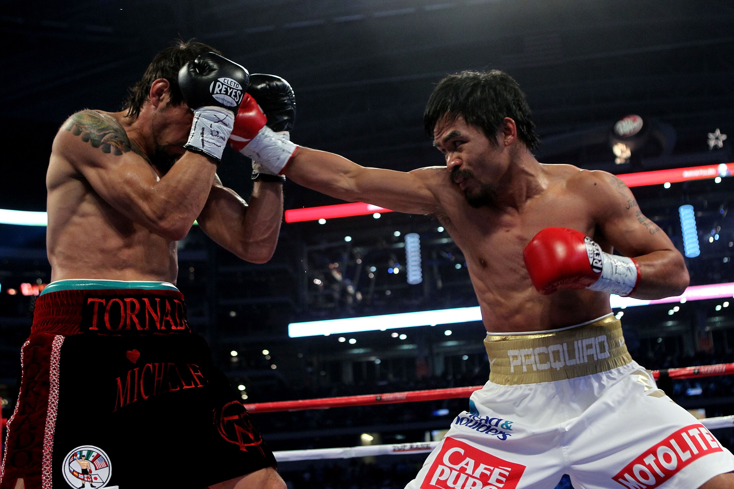 ARLINGTON, TX - NOVEMBER 13: Manny Pacquiao (white trunks) of the Philippines lands a punch against Antonio Margarito (black trunks) of Mexico during their WBC World Super Welterweight Title bout at Cowboys Stadium on November 13, 2010 in Arlington, Texa ARLINGTON, TX - NOVEMBER 13: Manny Pacquiao (white trunks) of the Philippines lands a punch against Antonio Margarito (black trunks) of Mexico during their WBC World Super Welterweight Title bout at Cowboys Stadium on November 13, 2010 in Arlington, Texa