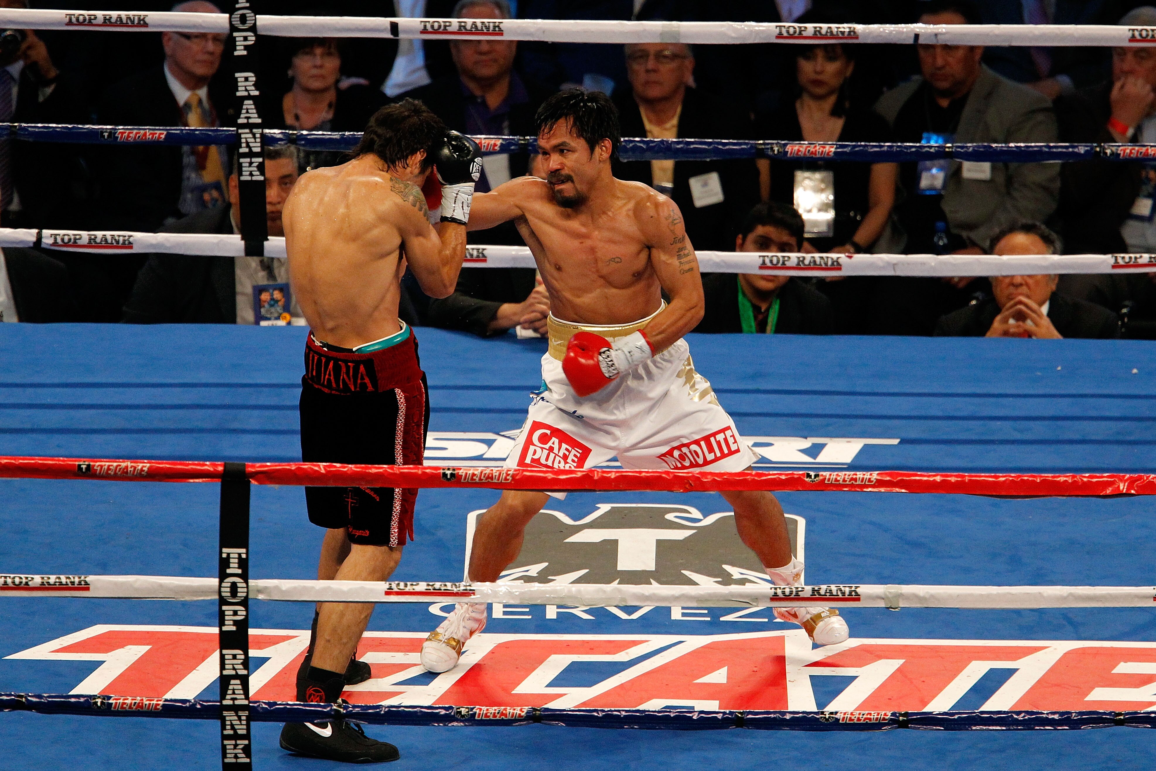 ARLINGTON, TX - NOVEMBER 13:  Manny Pacquiao (white trunks) of the Philippines fights against Antonio Margarito (black trunks) of Mexico during their WBC World Super Welterweight Title bout at Cowboys Stadium on November 13, 2010 in Arlington, Texas.  (Ph
