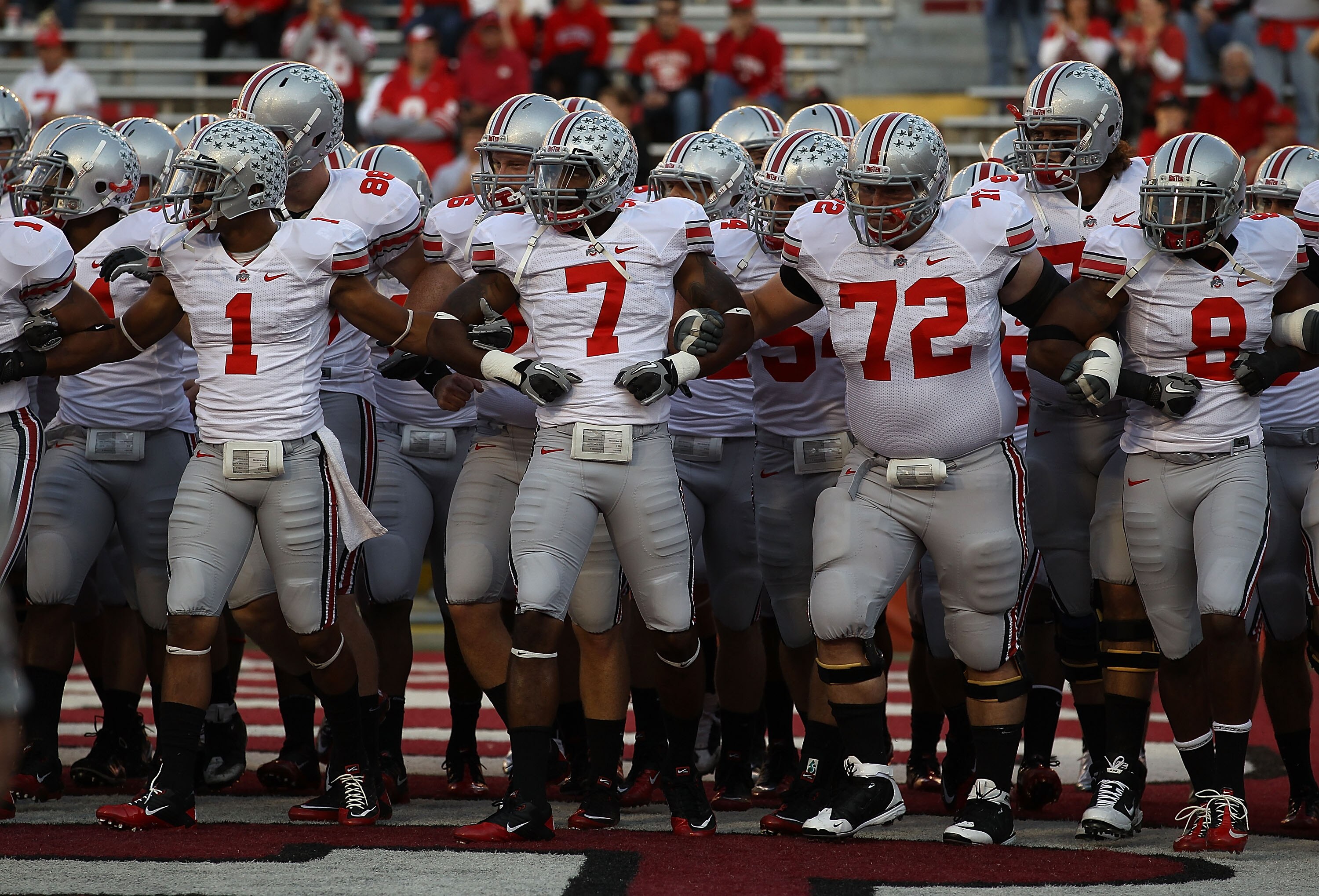 MADISON, WI - OCTOBER 16: Members of the Ohio State Buckeyes including Devon Torrence #1, Jermale Hines #7, Dexter Larimore #72 and Aaron Gant #8 walk on to the field for warm-ups before a game against the Wisconsin Badgers at Camp Randall Stadium on Octo