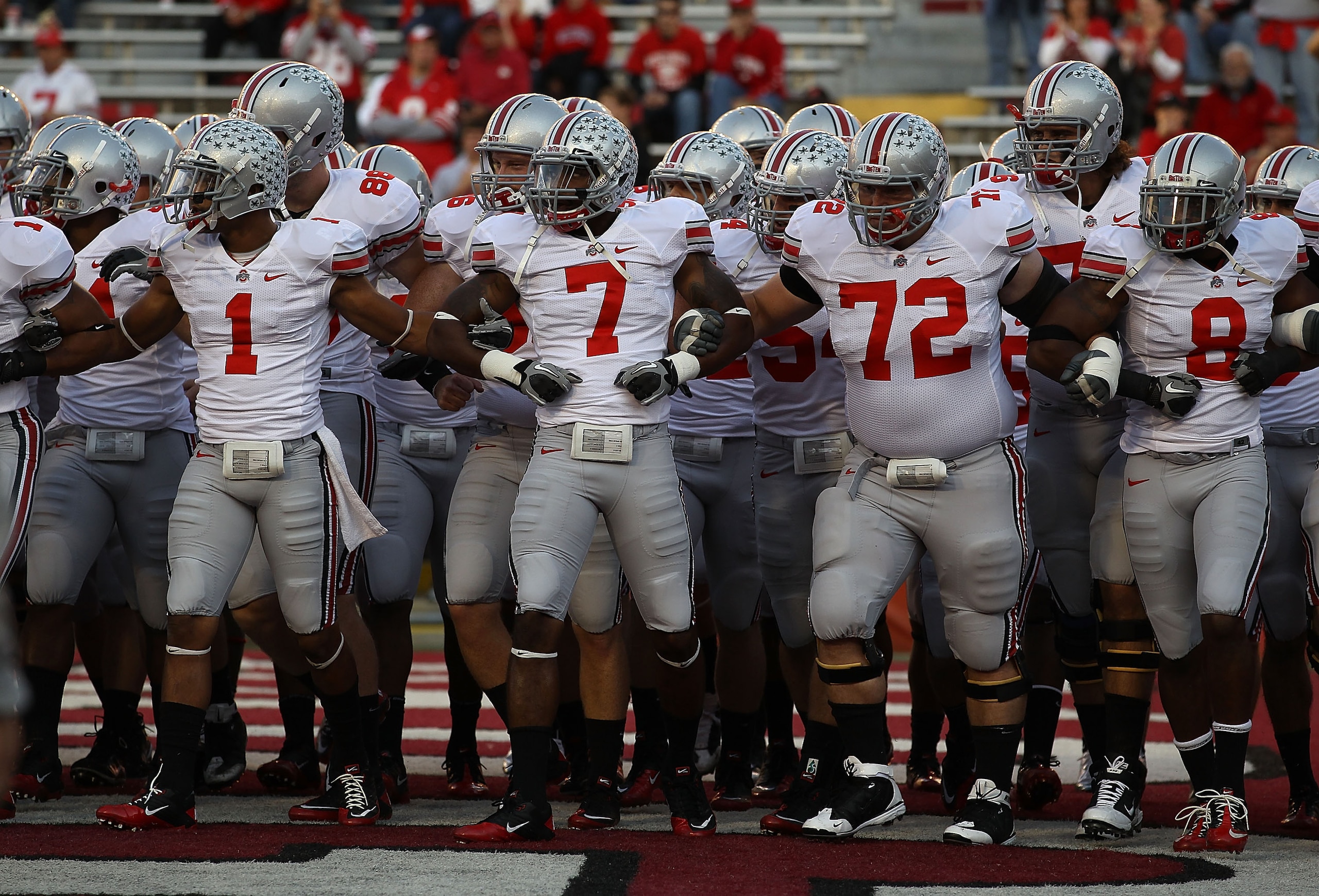 MADISON, WI - OCTOBER 16: Members of the Ohio State Buckeyes including Devon Torrence #1, Jermale Hines #7, Dexter Larimore #72 and Aaron Gant #8 walk on to the field for warm-ups before a game against the Wisconsin Badgers at Camp Randall Stadium on Octo