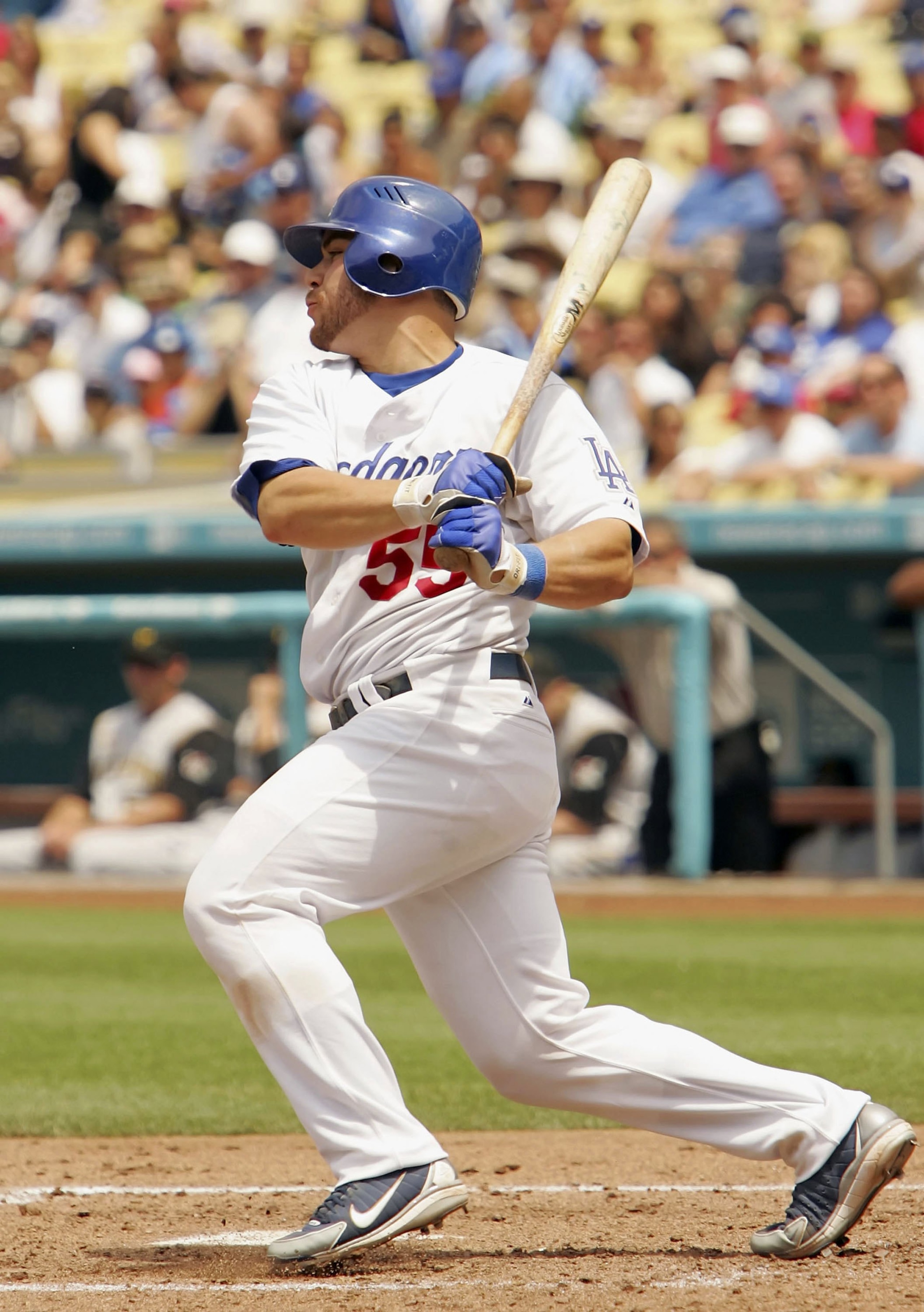 LOS ANGELES - JUNE 25:  Russell Martin #55 of the Los Angeles Dodgers hits an RBI single in the fourth inning against the Pittsburgh Pirates on June 25, 2006 at Dodger Stadium in Los Angeles, California.  The Dodgers won 7-4.  (Photo by Lisa Blumenfeld/Ge