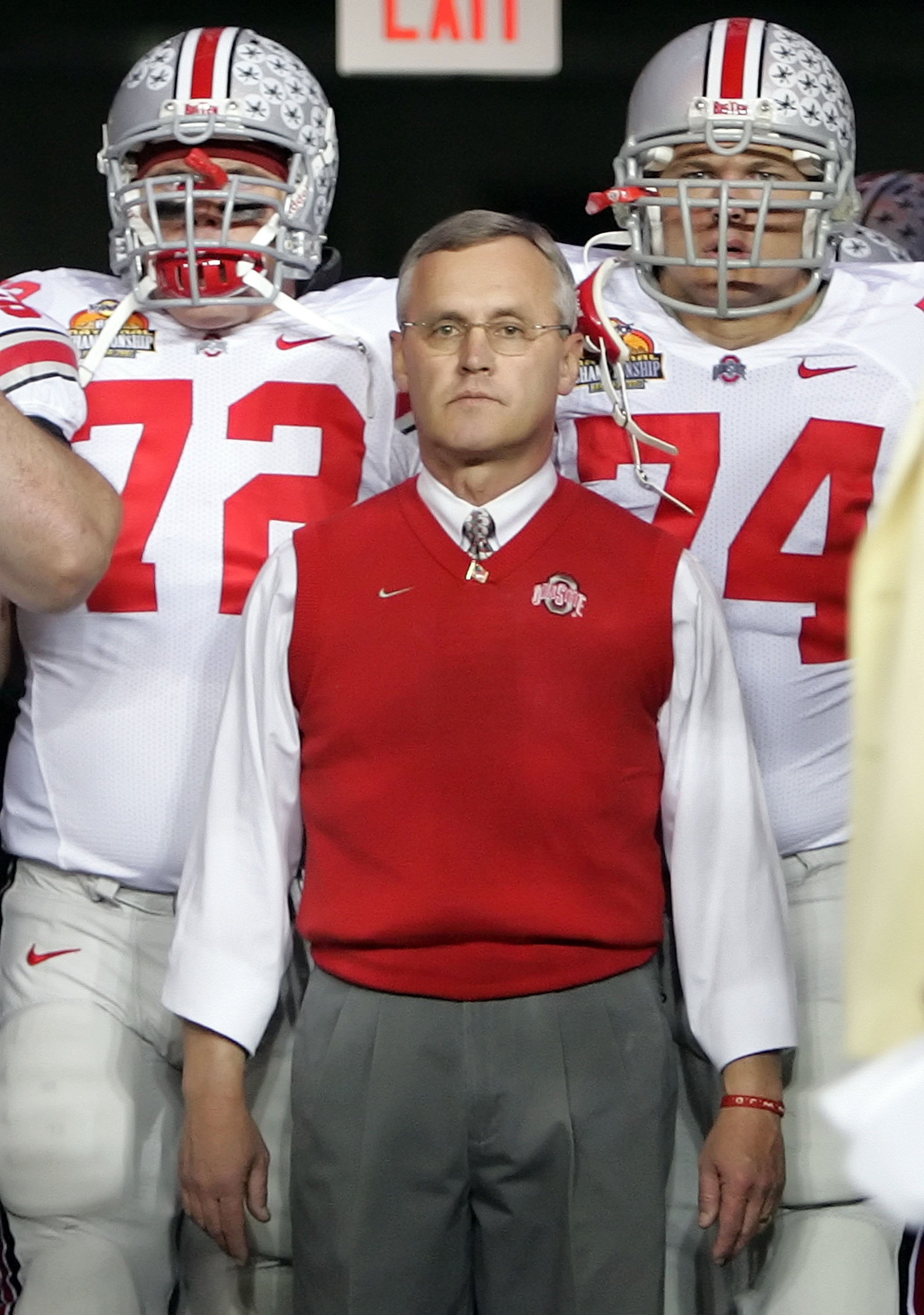 GLENDALE, AZ - JANUARY 08:  Head coach Jim Tressel of the Ohio State Buckeyes stands in front of lineman Dexter Larimore #72 and Kirk Barton #74 as they enter the field against the Florida Gators at the 2007 Tostitos BCS National Championship Game at the