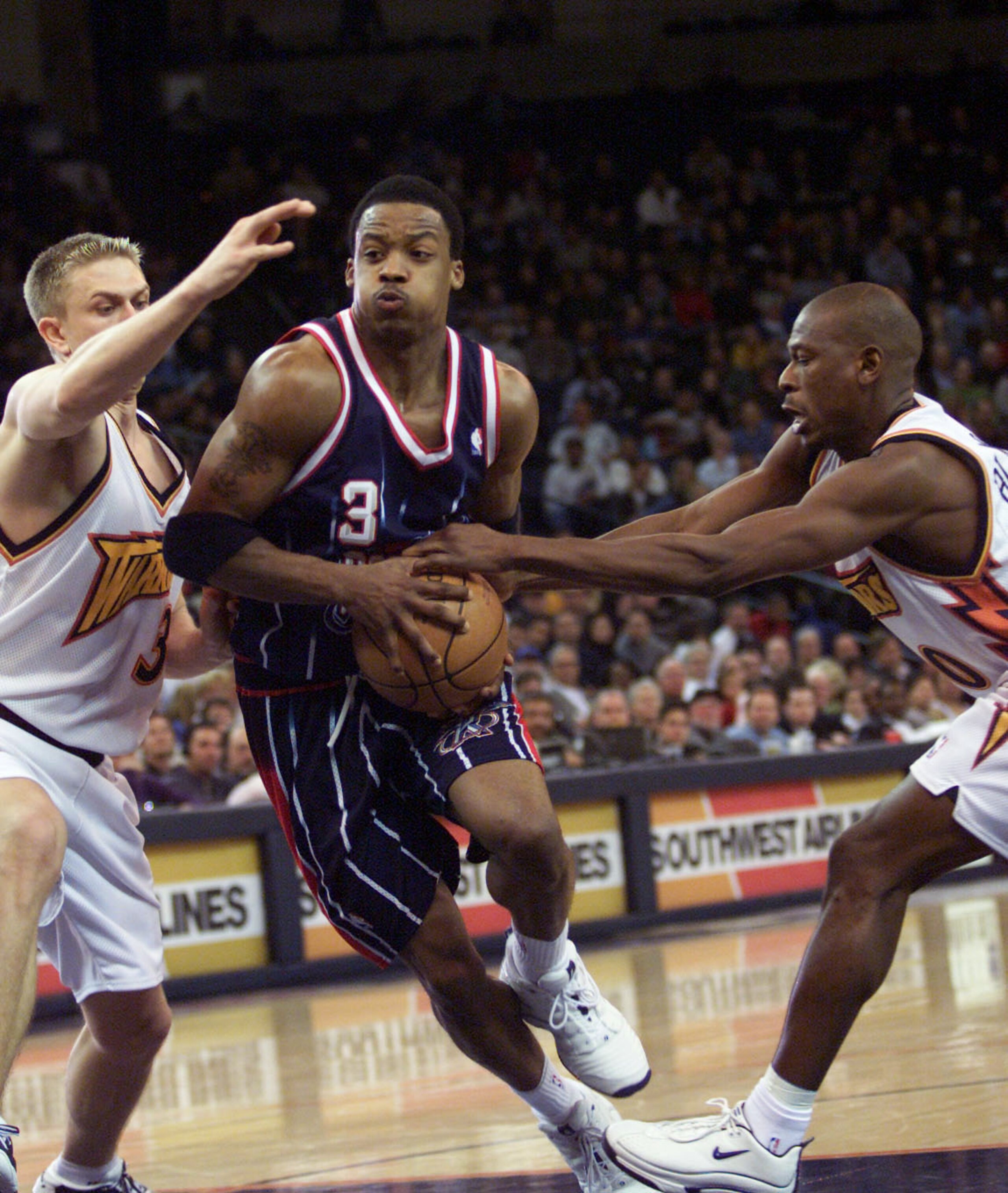 18 Jan 2001: Steve Francis #3 of the Houston Rockets drives to the hoop as Bob Sura #3 and Mookie Blaylock #10 of the Golden State Warriors grab for the ball at the Arena in Oakland, California. DIGITAL IMAGE Mandatory Credit: Tom Hauck/ALLSPORT  NOTE TO 
