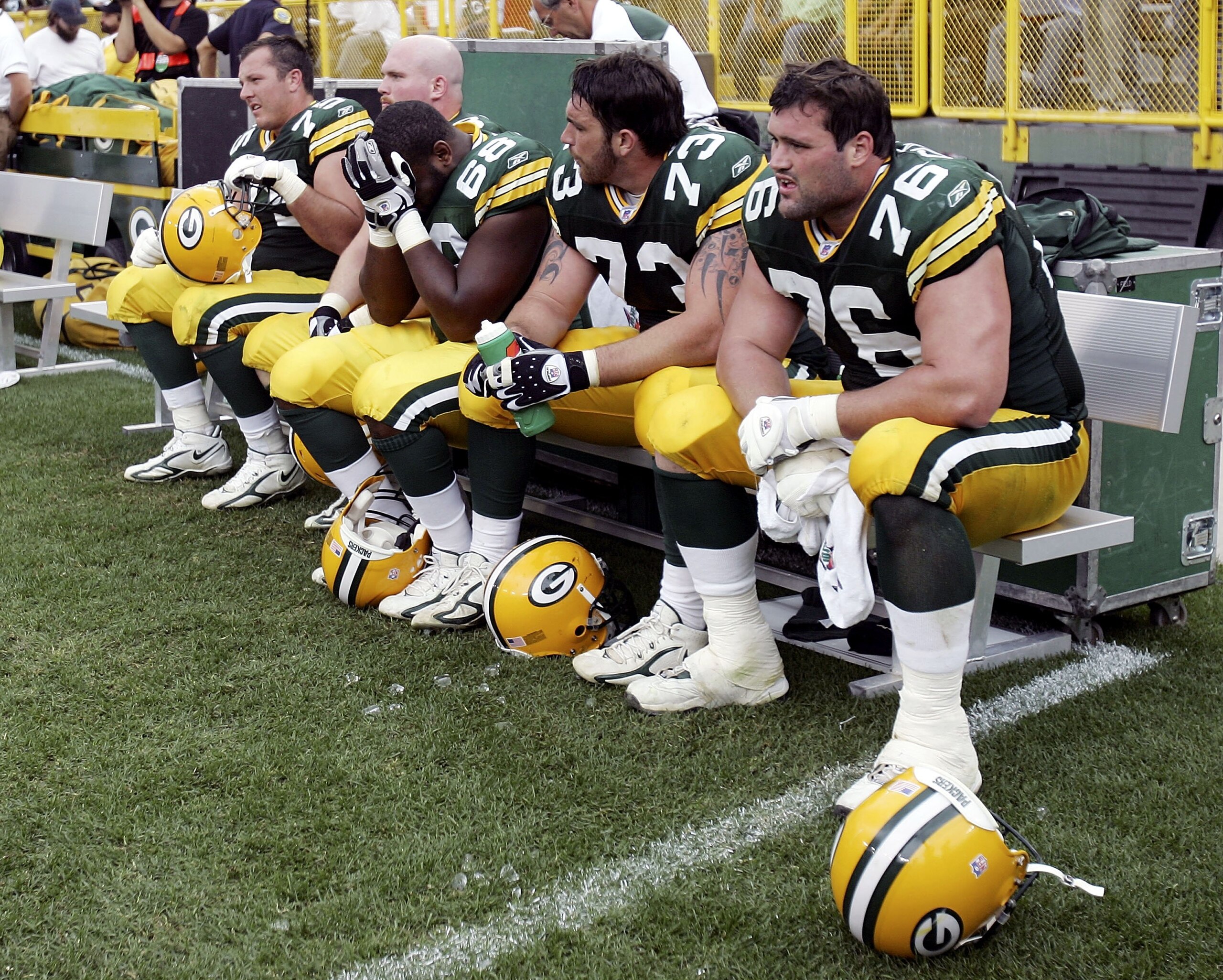 GREEN BAY, WI - SEPTEMBER 17: The offensive line of the Green Bay Packers sits dejected in the final minutes of the game against the New Orleans Saints on September 17, 2006 at Lambeau Field in Green Bay, Wisconsin. The New Orleans Saints defeated the Gr GREEN BAY, WI - SEPTEMBER 17: The offensive line of the Green Bay Packers sits dejected in the final minutes of the game against the New Orleans Saints on September 17, 2006 at Lambeau Field in Green Bay, Wisconsin. The New Orleans Saints defeated the Gr