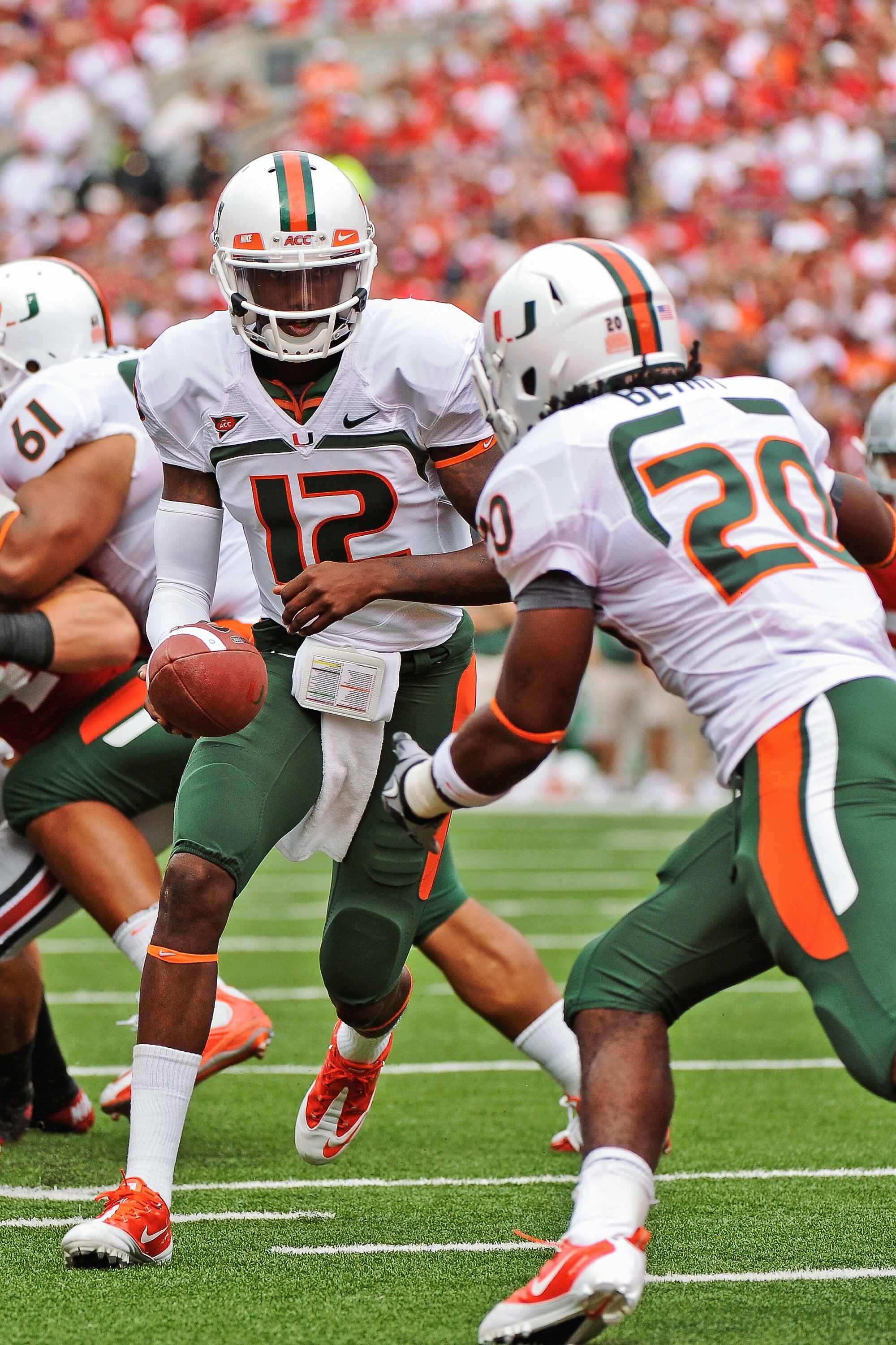 COLUMBUS, OH - SEPTEMBER 11:  Quarterback Jacory Harris #12 of the Miami Hurricanes hands the ball off to a running back against the Ohio State Buckeyes at Ohio Stadium on September 11, 2010 in Columbus, Ohio.  (Photo by Jamie Sabau/Getty Images)