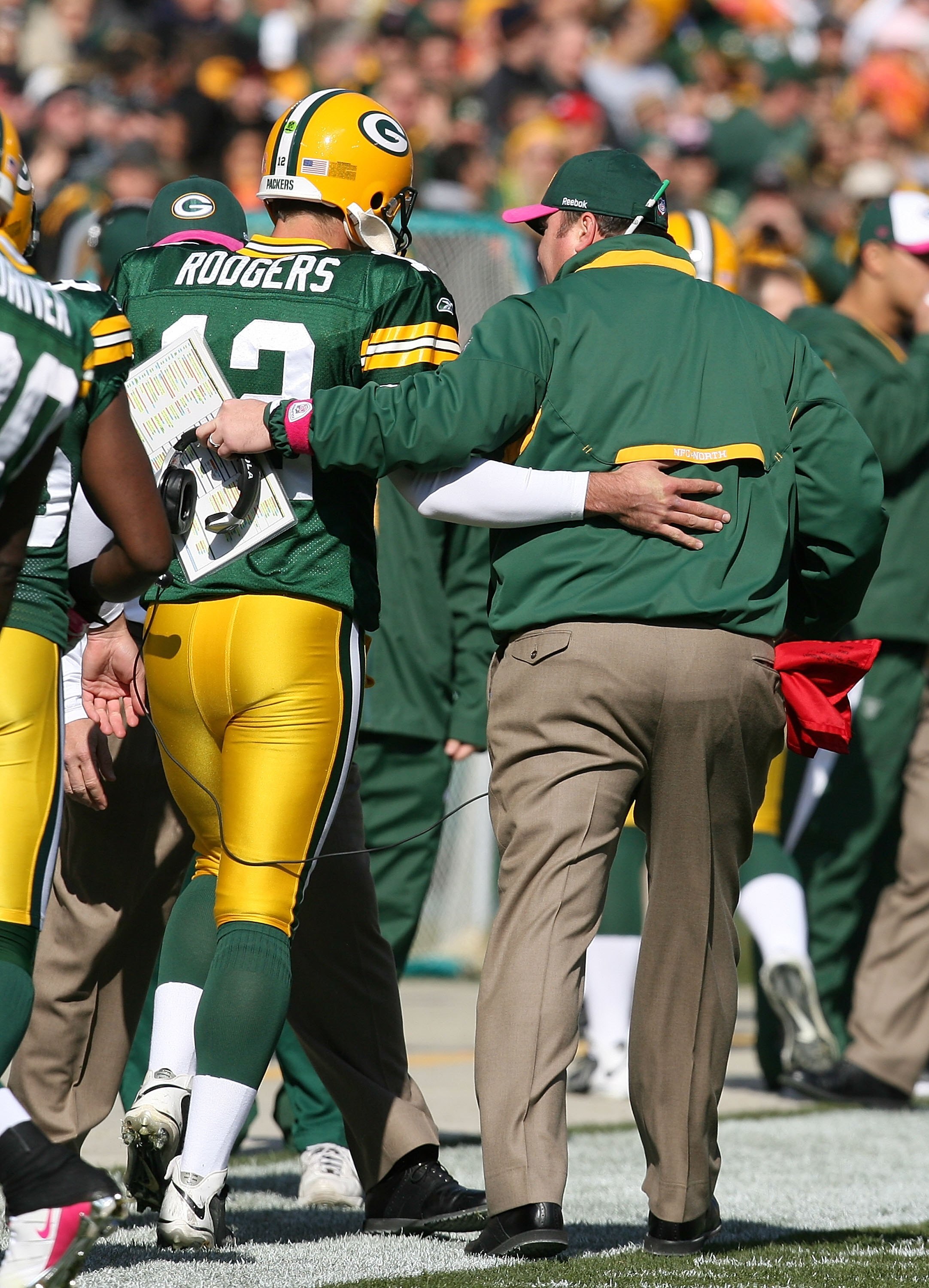 GREEN BAY, WI - OCTOBER 18: Aaron Rodgers #12 of the Green Bay Packers talks with head coach Mike McCarthy during a game against the Detroit Lions at Lambeau Field on October 18, 2009 in Green Bay, Wisconsin. The Packers defeated the Lions 26-0.  (Photo b