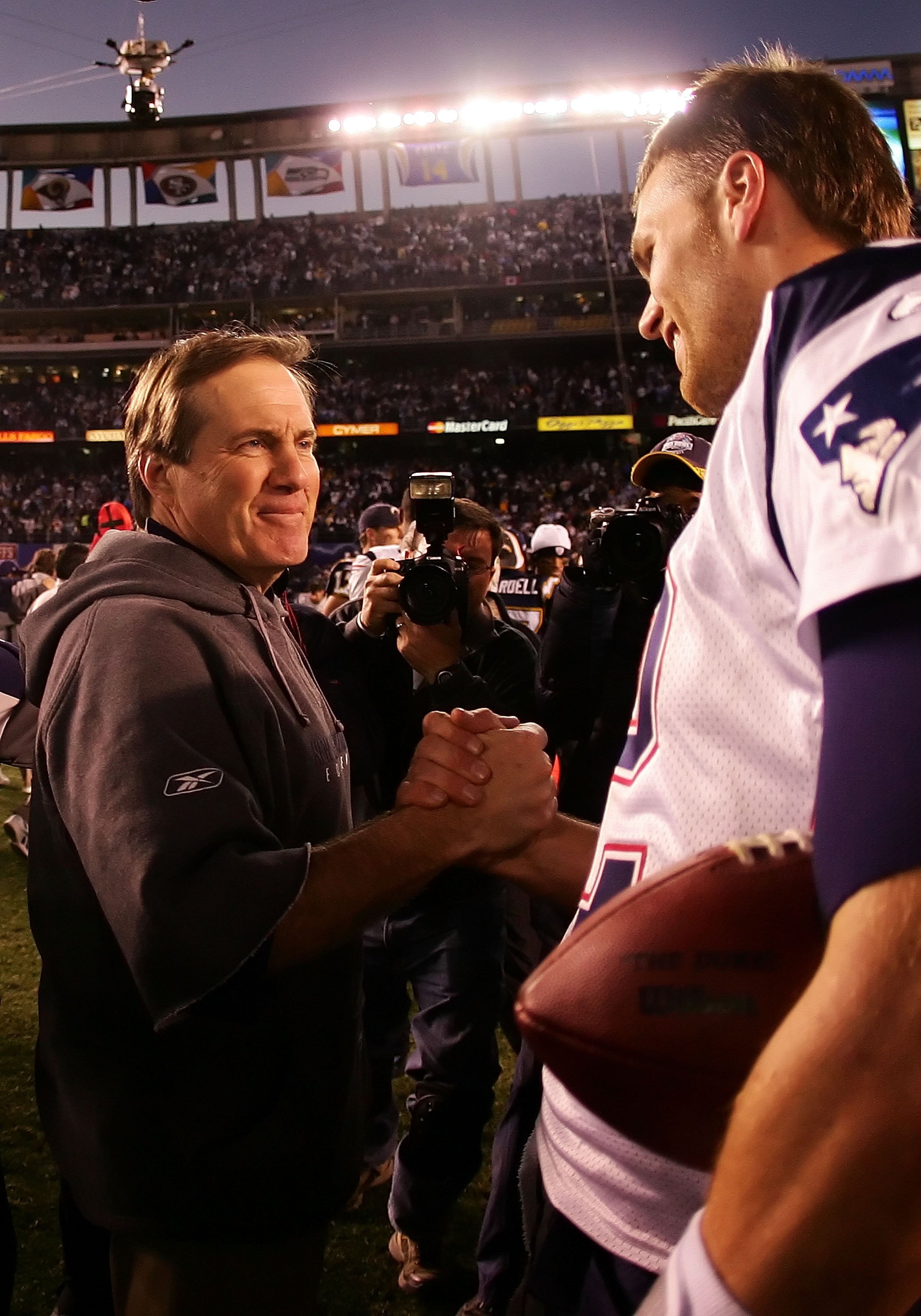 SAN DIEGO - JANUARY 14:  (L-R) Head coach Bill Belichick and quarterback Tom Brady #12 of the New England Patriots meet after the game against the San Diego Chargers after the AFC Divisional Playoff Game held on January 14, 2007 at Qualcomm Stadium in San