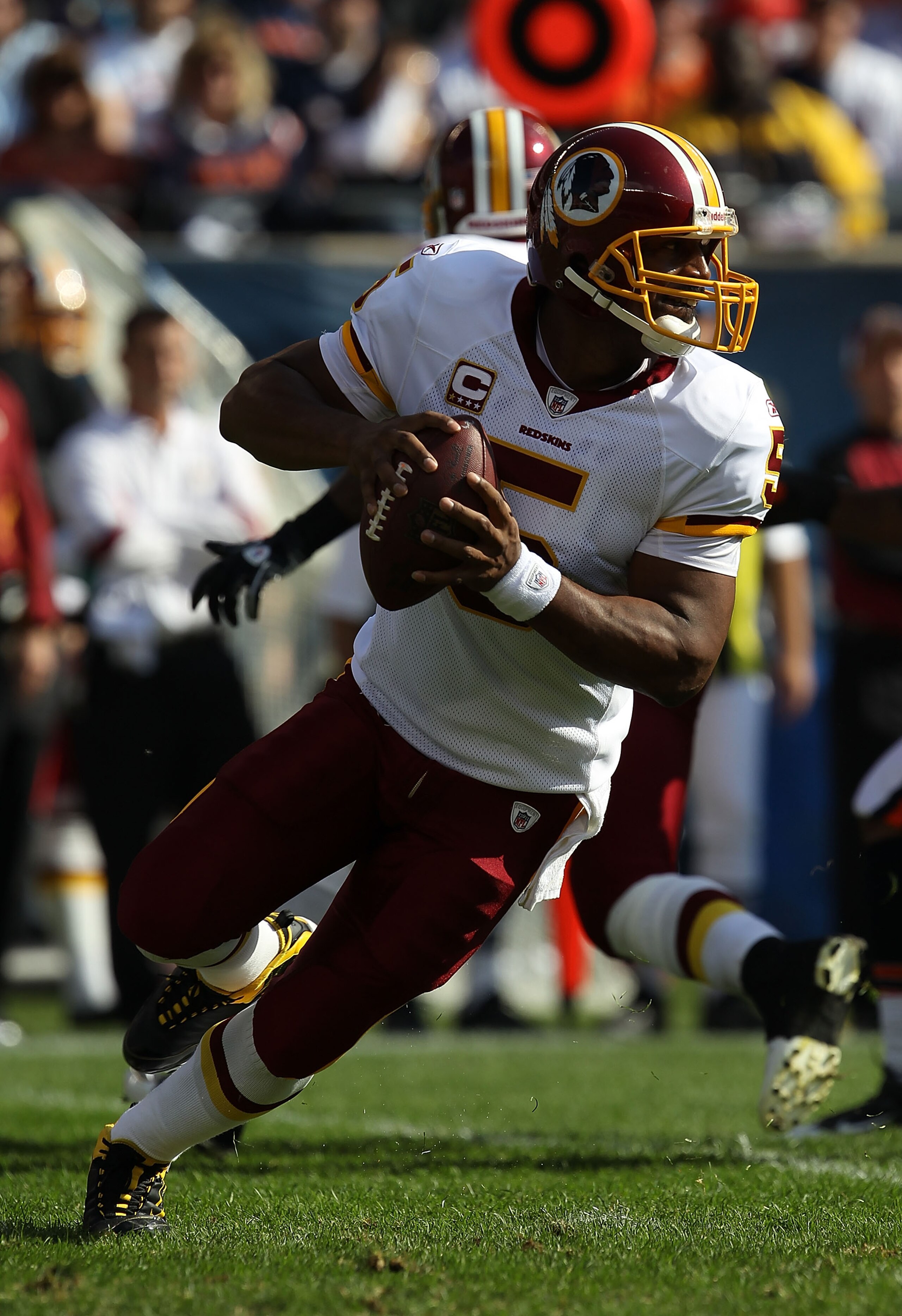 CHICAGO - OCTOBER 24: Donovan McNabb #5 of the Washington Redskins rolls out to look for a receiver against the Chicago Bears at Soldier Field on October 24, 2010 in Chicago, Illinois.  The Redskins defeated the Bears 17-14. (Photo by Jonathan Daniel/Gett