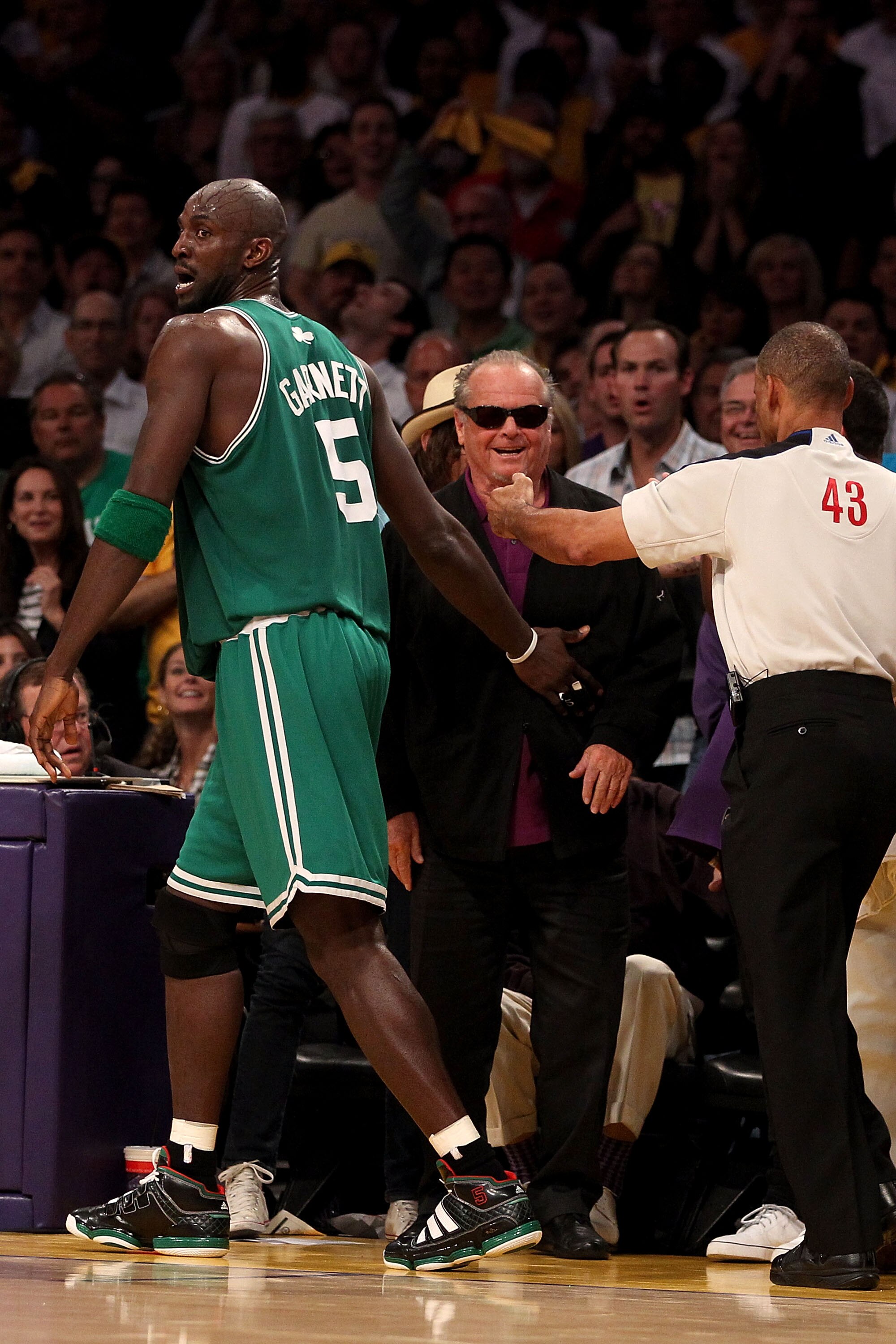 LOS ANGELES, CA - JUNE 17:  Kevin Garnett #5 of the Boston Celtics walks past actor Jack Nicholson after Garmett fell out of bounds in the first half against the Los Angeles Lakers in Game Seven of the 2010 NBA Finals at Staples Center on June 17, 2010 in