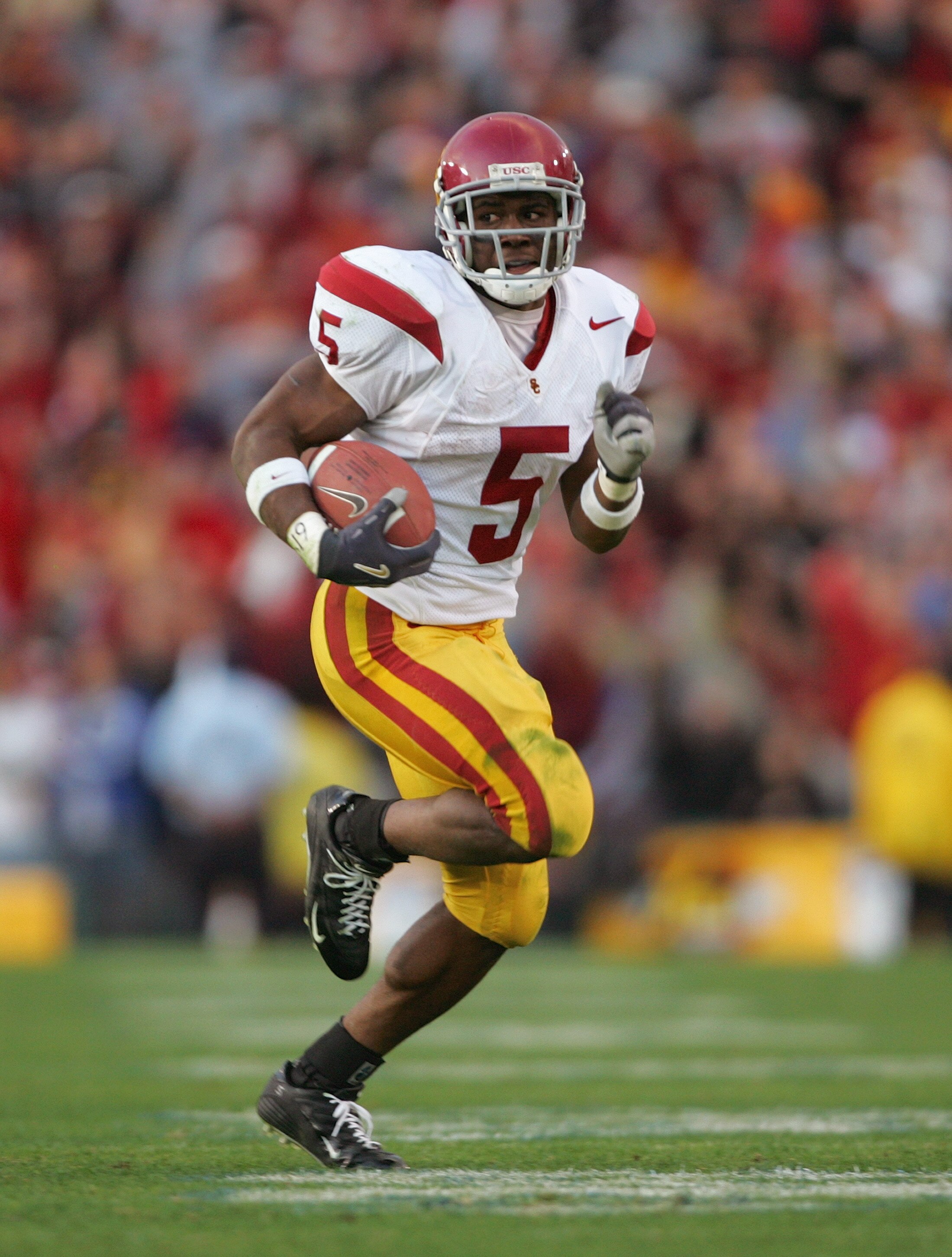 PASADENA, CA - DECEMBER 4:  Reggie Bush #5 of the USC Trojans carries the ball during the game against the UCLA Bruins on December 4, 2004 at the Rose Bowl in Pasadena, California.  USC won 29-24. (Photo by Harry How/Getty Images)