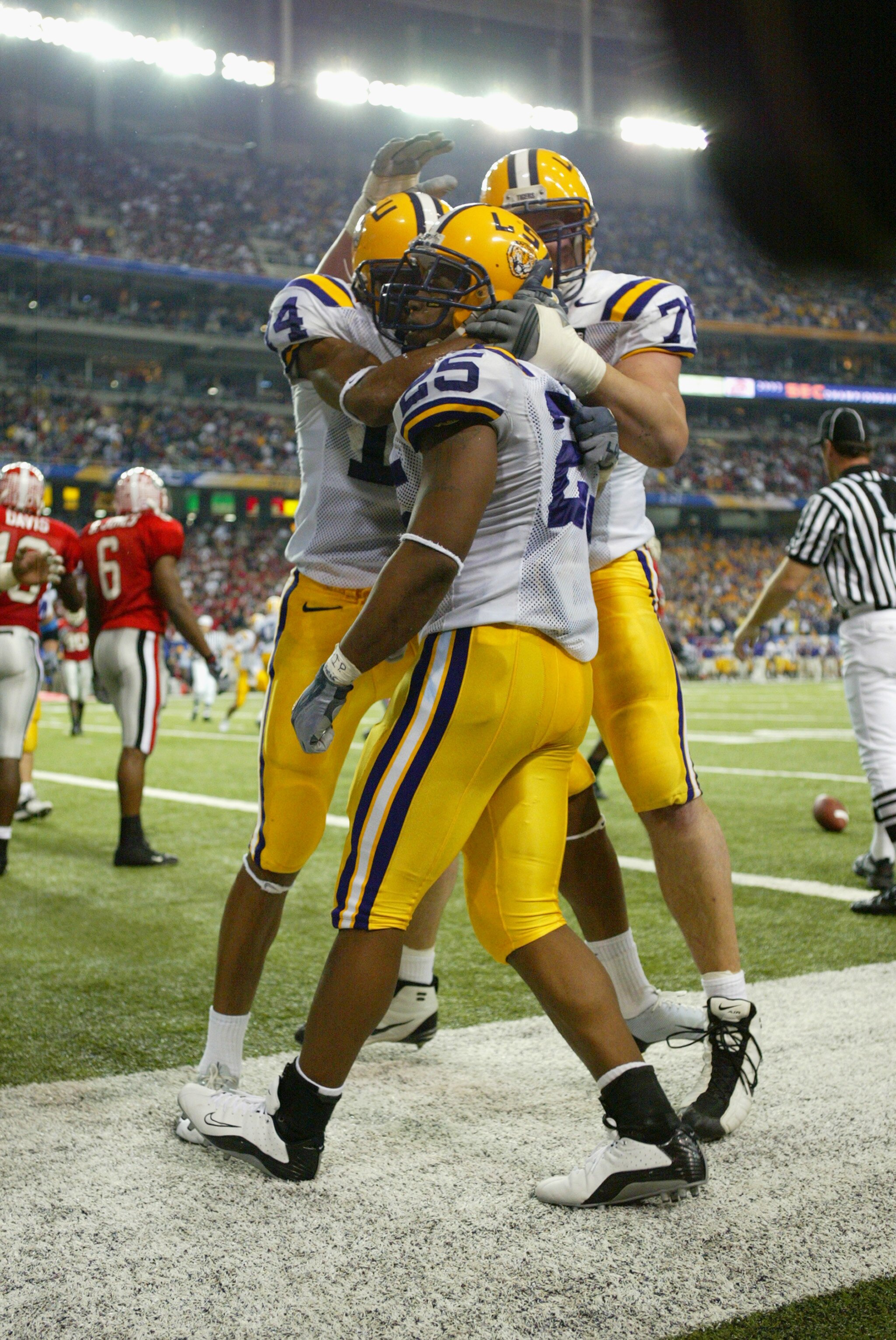 ATLANTA, GA - DECEMBER 6:  Running back Justin Vincent #25 of the LSU Tigers celebrates with two teammates during the game against the Georgia Bulldogs in the SEC Championship Game on December 6, 2003 at the Georgia Dome in Atlanta, Georgia. LSU defeated