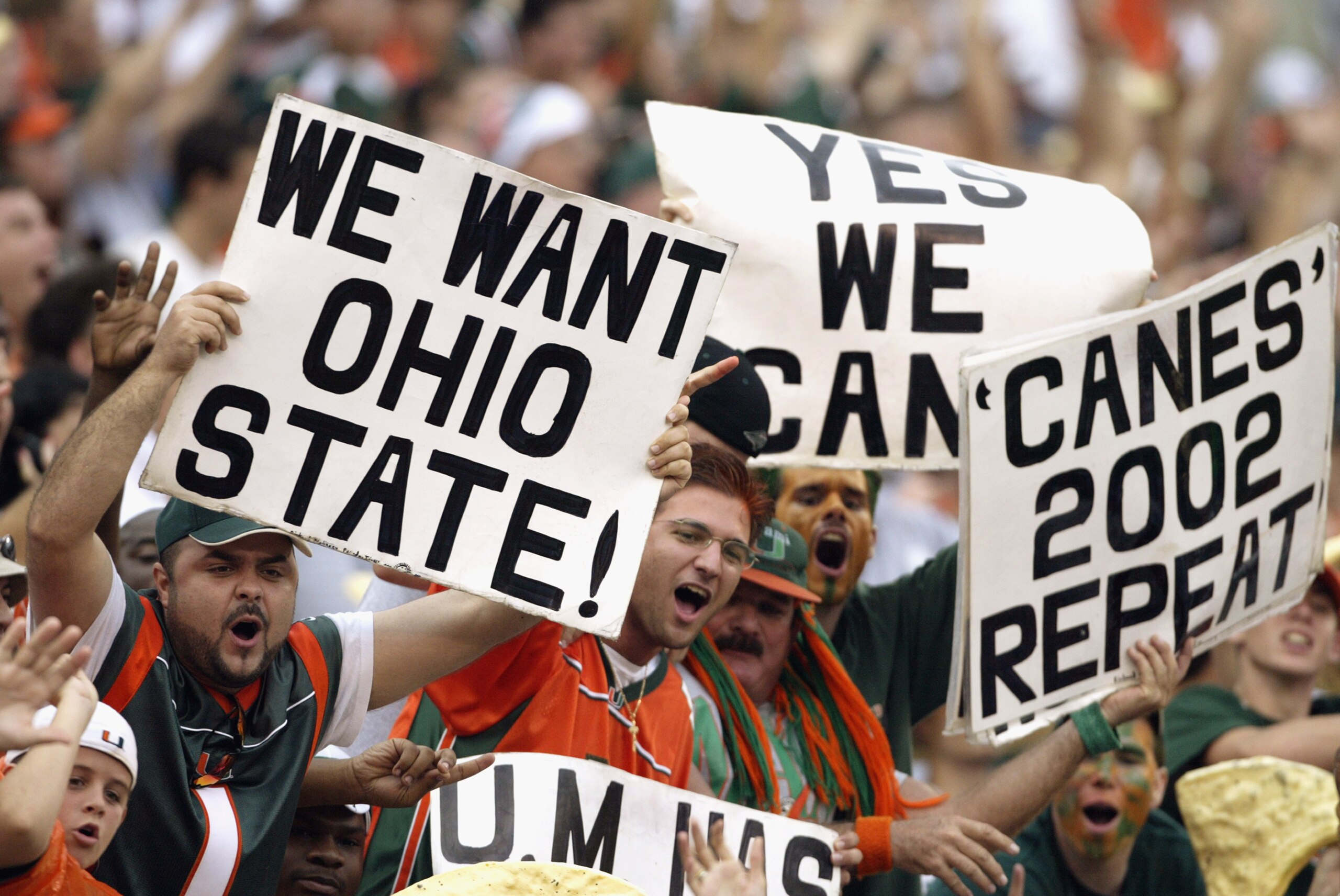MIAMI - DECEMBER 7:  Fans of the University of Miami Hurricanes want their team to take on the Ohio State University Buckeyes during the game against the Virginia Polytechnic Institute and State University Hokies at the Orange Bowl on December 7, 2002 in