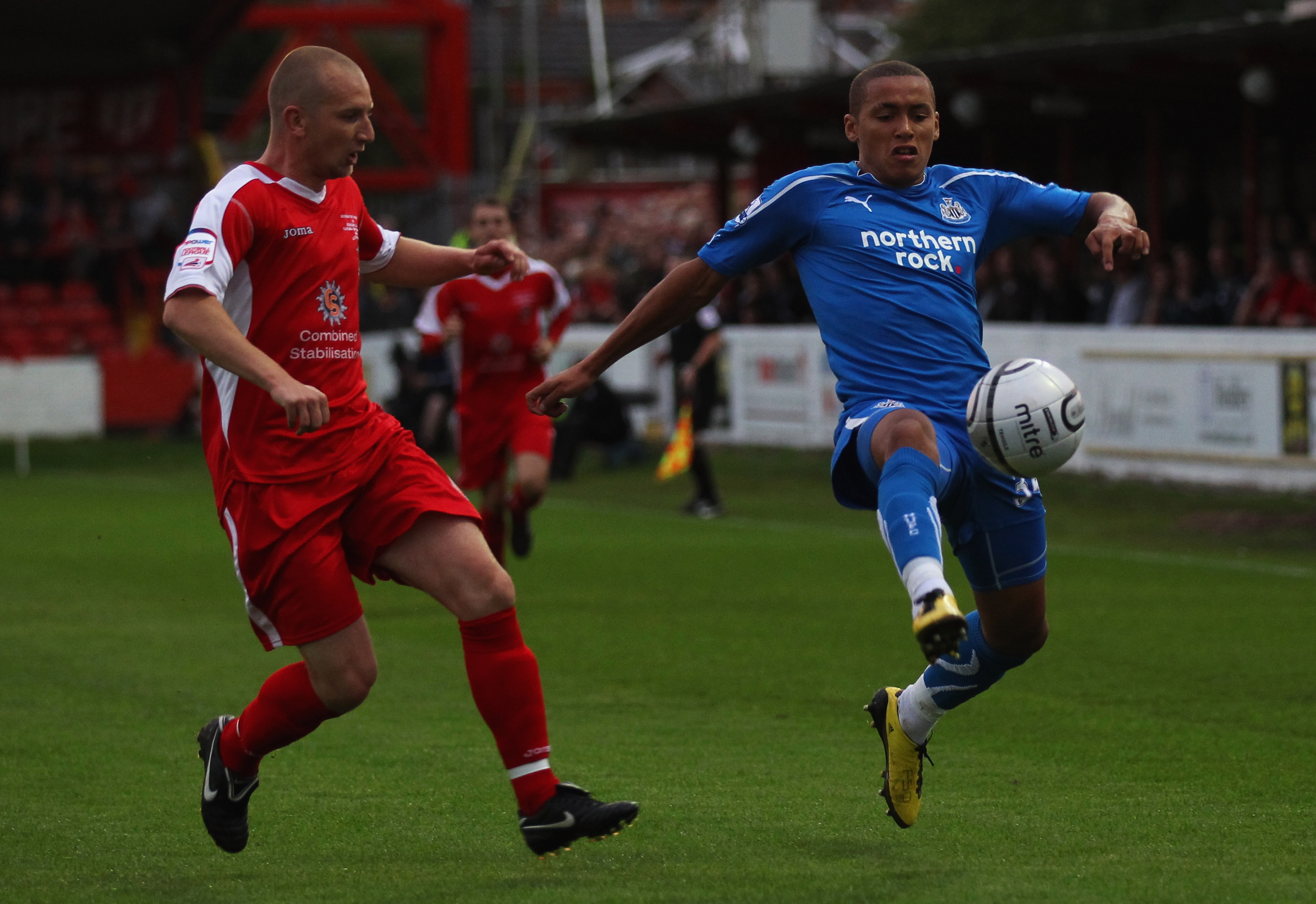 ACCRINGTON, ENGLAND - AUGUST 25:  James Tavernier of Newcastle United beats Andrew Parkinson of Accrington Stanley to the ball during the Carling Cup 2nd Round match between Accrington Stanley and Newcastle United at the Crown Ground on August 25, 2010 in