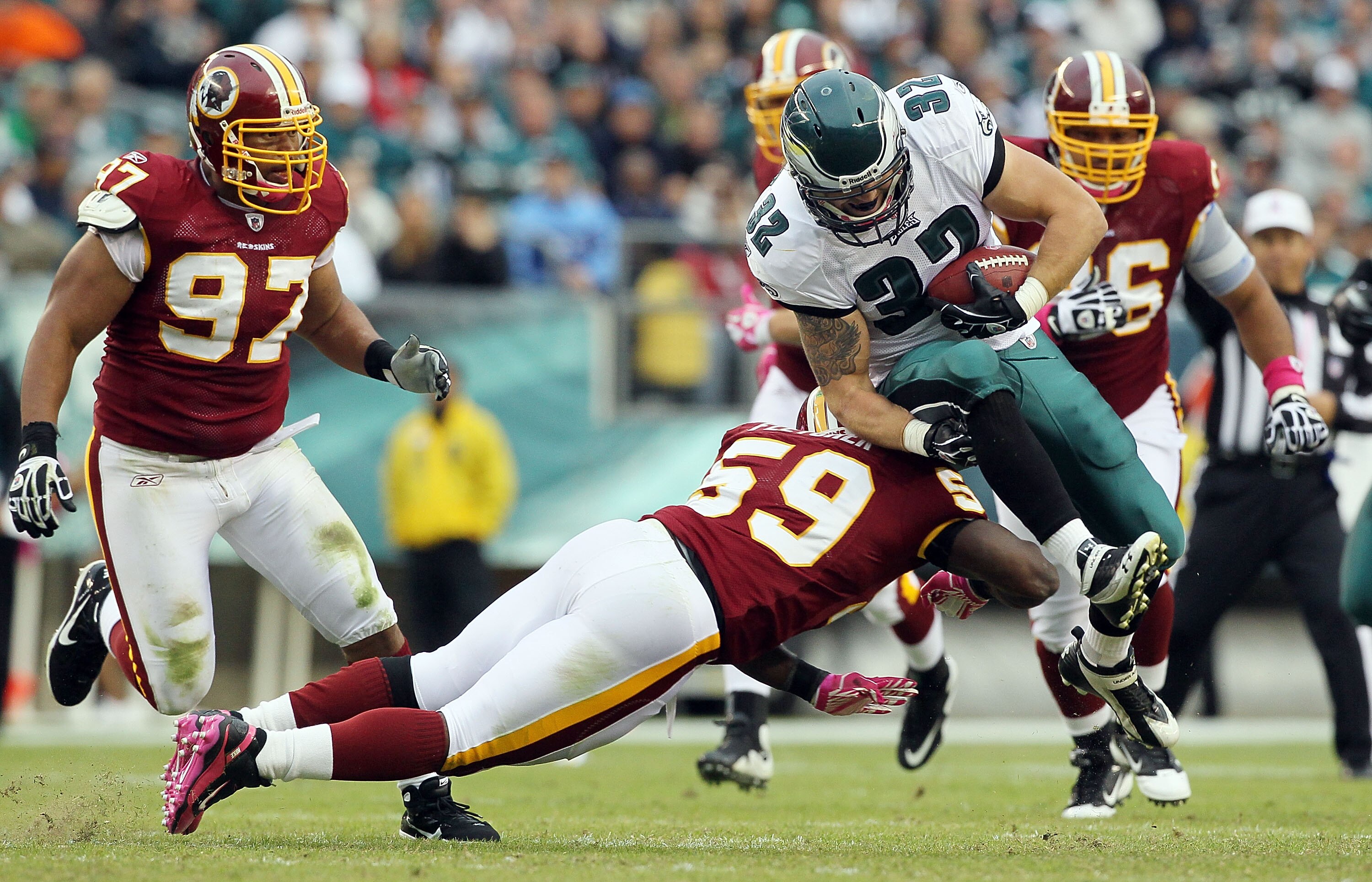 PHILADELPHIA - OCTOBER 03:  Owen Schmitt #32 of the Philadelphia Eagles is tackled by London Fletcher #59 of the Washington Redskins on October 3, 2010 at Lincoln Financial Field in Philadelphia, Pennsylvania.  (Photo by Jim McIsaac/Getty Images)