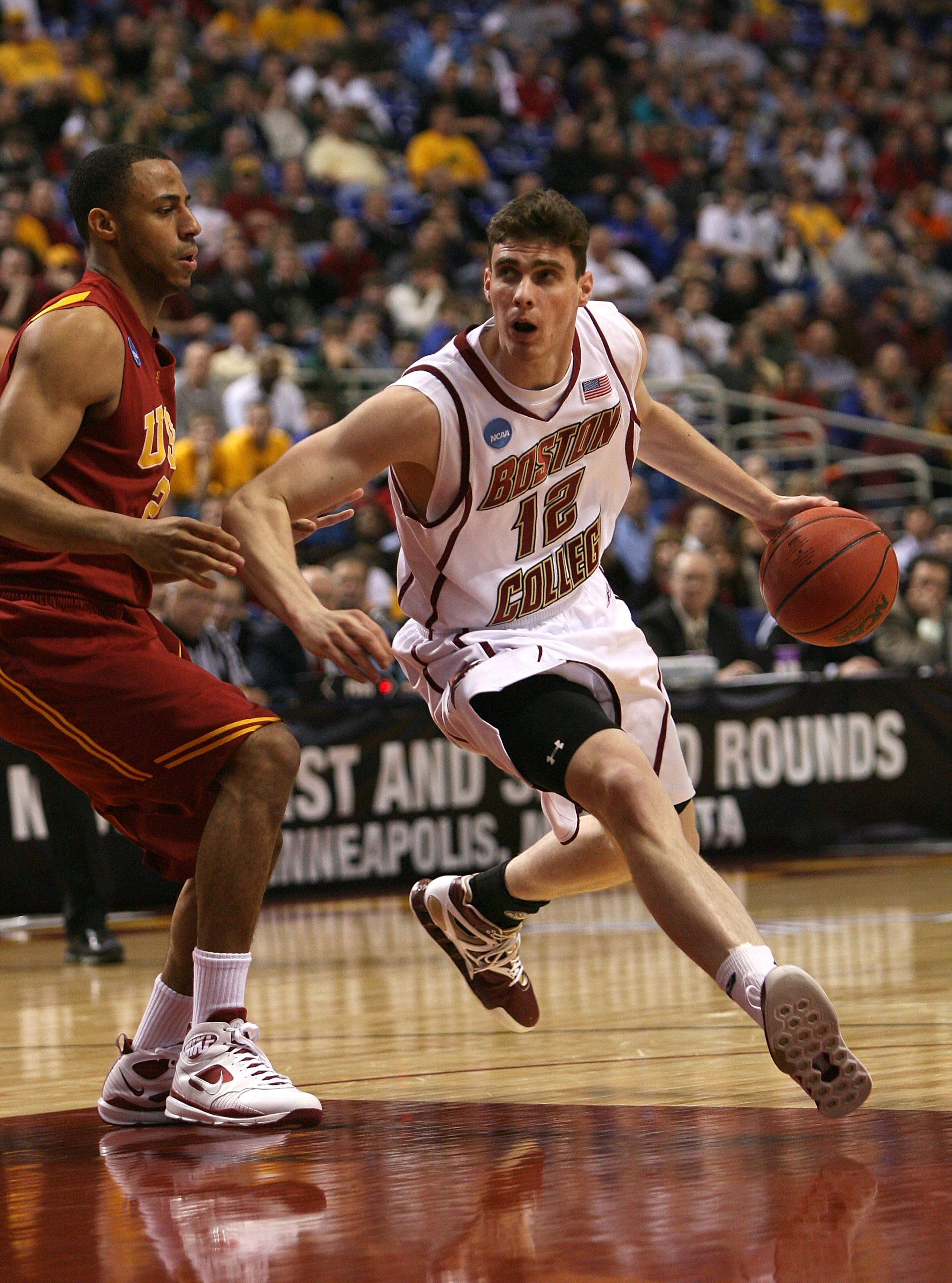 MINNEAPOLIS - MARCH 20: Joe Trapani #12 of the Boston College Eagles drives against Dwight Lewis #21 of the USC Trojans during the first round of the NCAA Division I Men's Basketball Tournament at the Hubert H. Humphrey Metrodome on March 20, 2009 in Min MINNEAPOLIS - MARCH 20: Joe Trapani #12 of the Boston College Eagles drives against Dwight Lewis #21 of the USC Trojans during the first round of the NCAA Division I Men's Basketball Tournament at the Hubert H. Humphrey Metrodome on March 20, 2009 in Min