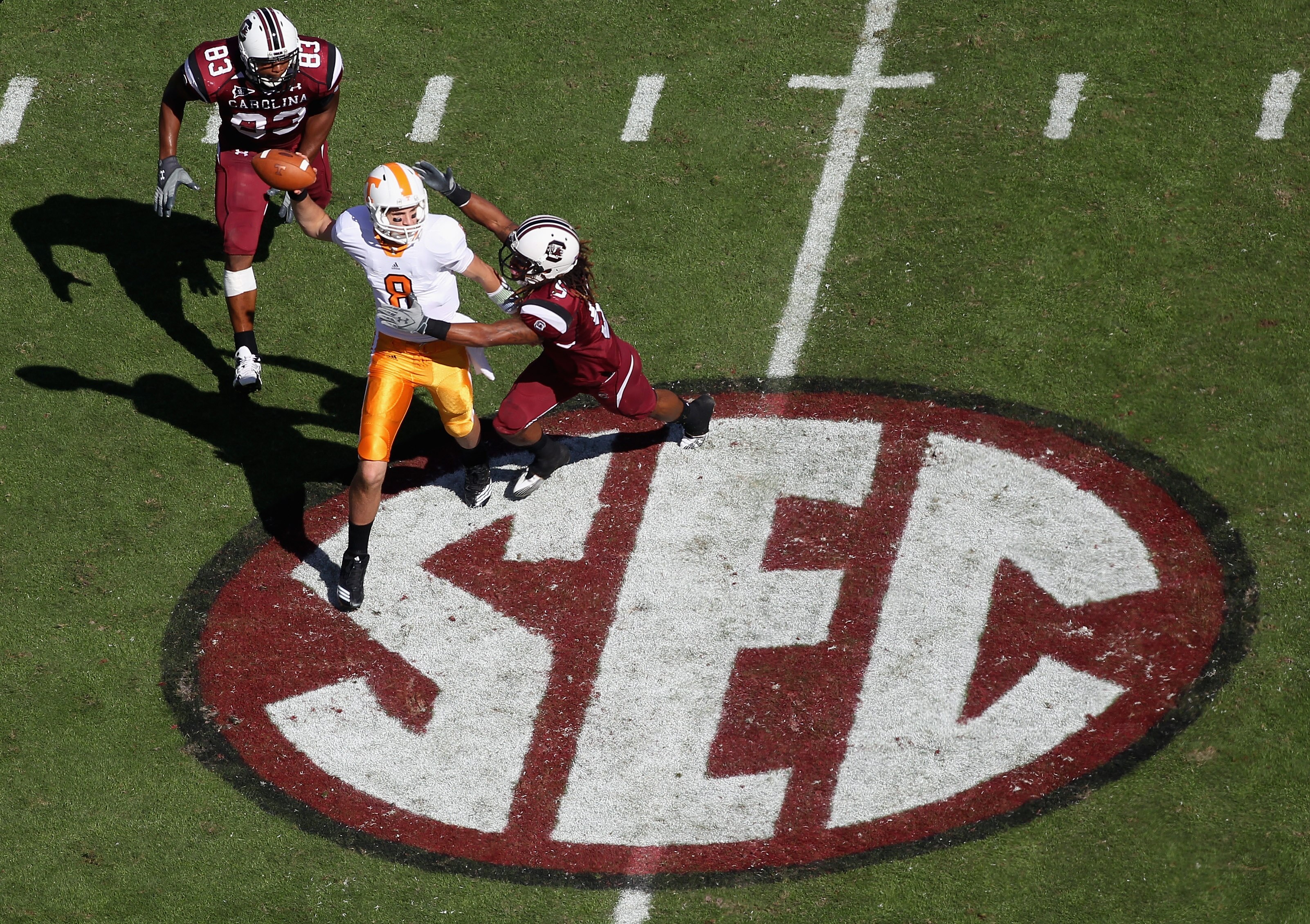COLUMBIA, SC - OCTOBER 30:  Tyler Bray #8 of the Tennessee Volunteers chased by teammates Stephon Gilmore #5 and Cliff Matthews #83 of the South Carolina Gamecocks during their game at Williams-Brice Stadium on October 30, 2010 in Columbia, South Carolina