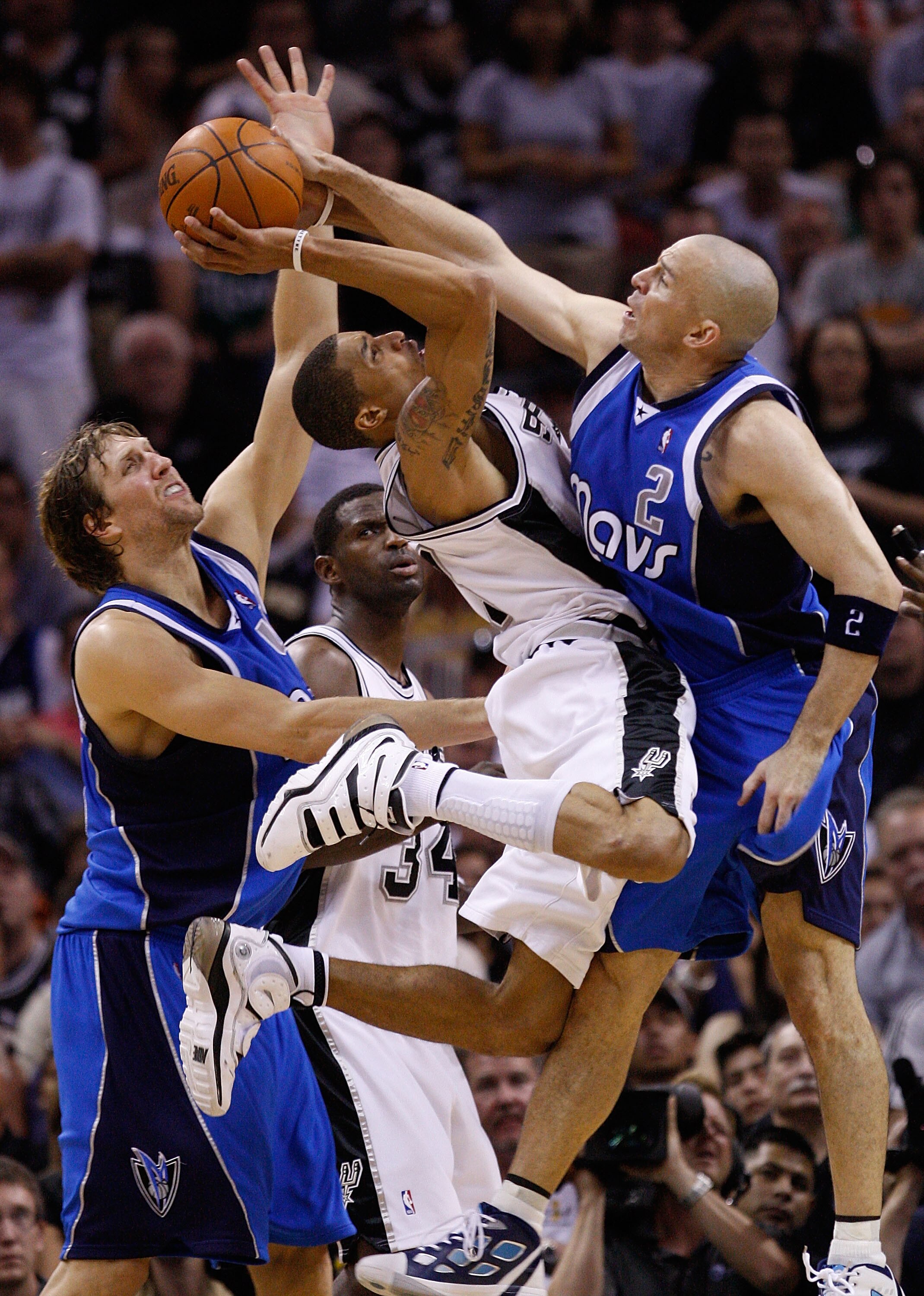 SAN ANTONIO - APRIL 25:  Guard George Hill #3 of the San Antonio Spurs takes a shot against Jason Kidd #2 and Dirk Nowitzki #41 of the Dallas Mavericks in Game Four of the Western Conference Quarterfinals during the 2010 NBA Playoffs at AT&T Center on Apr