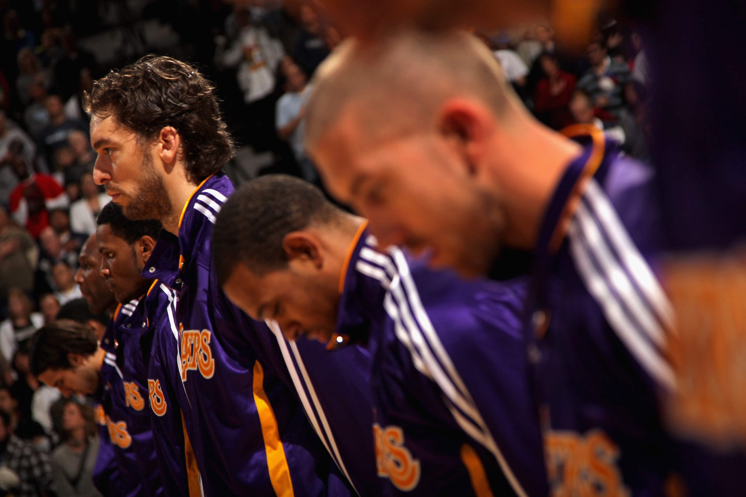 DENVER - NOVEMBER 11:  Pau Gasol #16 (L) and the Los Angeles Lakers observe the national anthem prior to facing the Denver Nuggets at the Pepsi Center on November 11, 2010 in Denver, Colorado. The Nuggets defeated the Lakers 118-112.  NOTE TO USER: User e