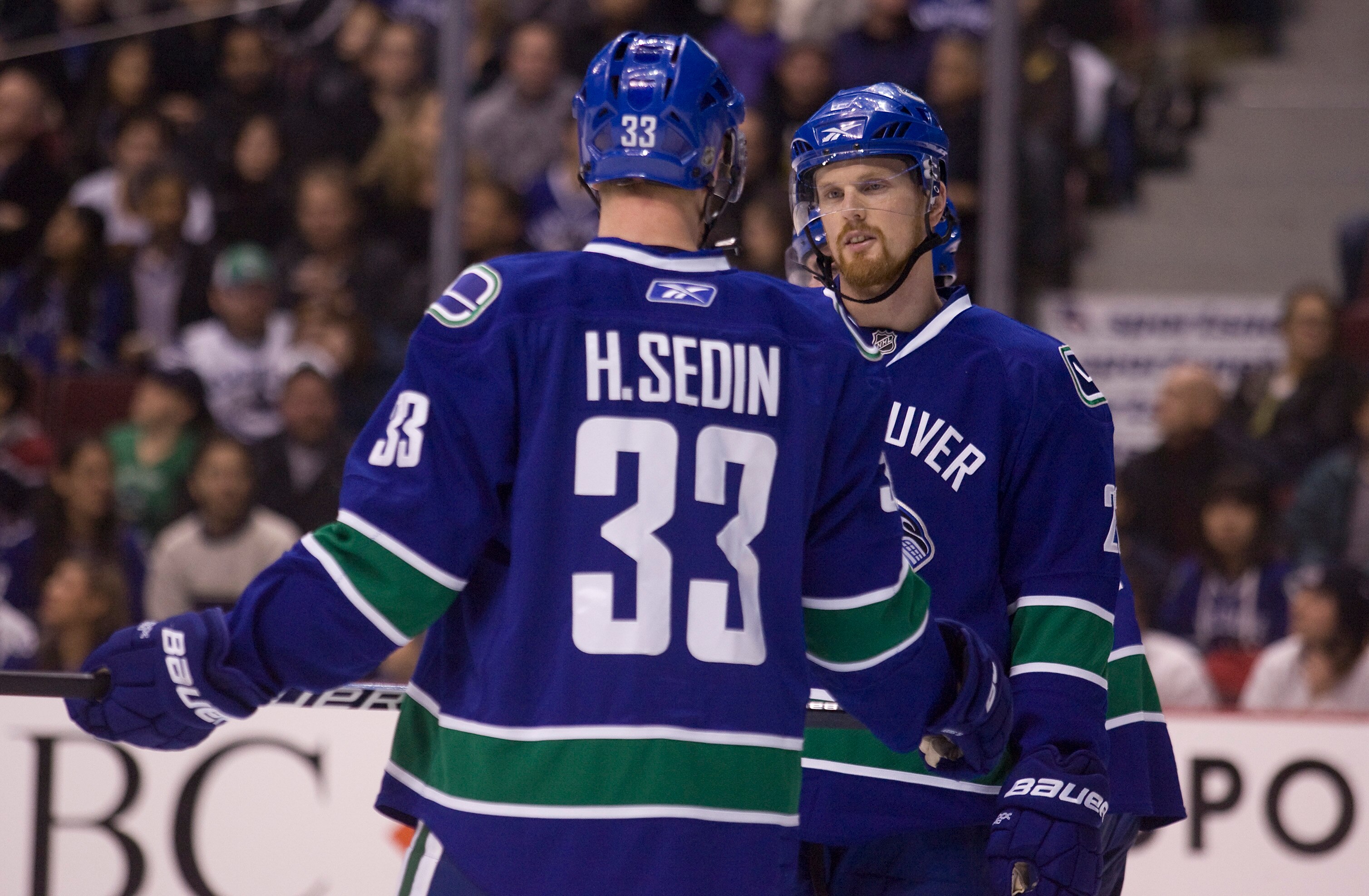 VANCOUVER, CANADA - JANUARY 7: Brothers Henrik Sedin #33 and Daniel Sedin #22 of the Vancouver Canucks talk things over prior to a face-off during the second period of NHL action against the Phoenix Coyotes on January 07, 2010 at General Motors Place in V