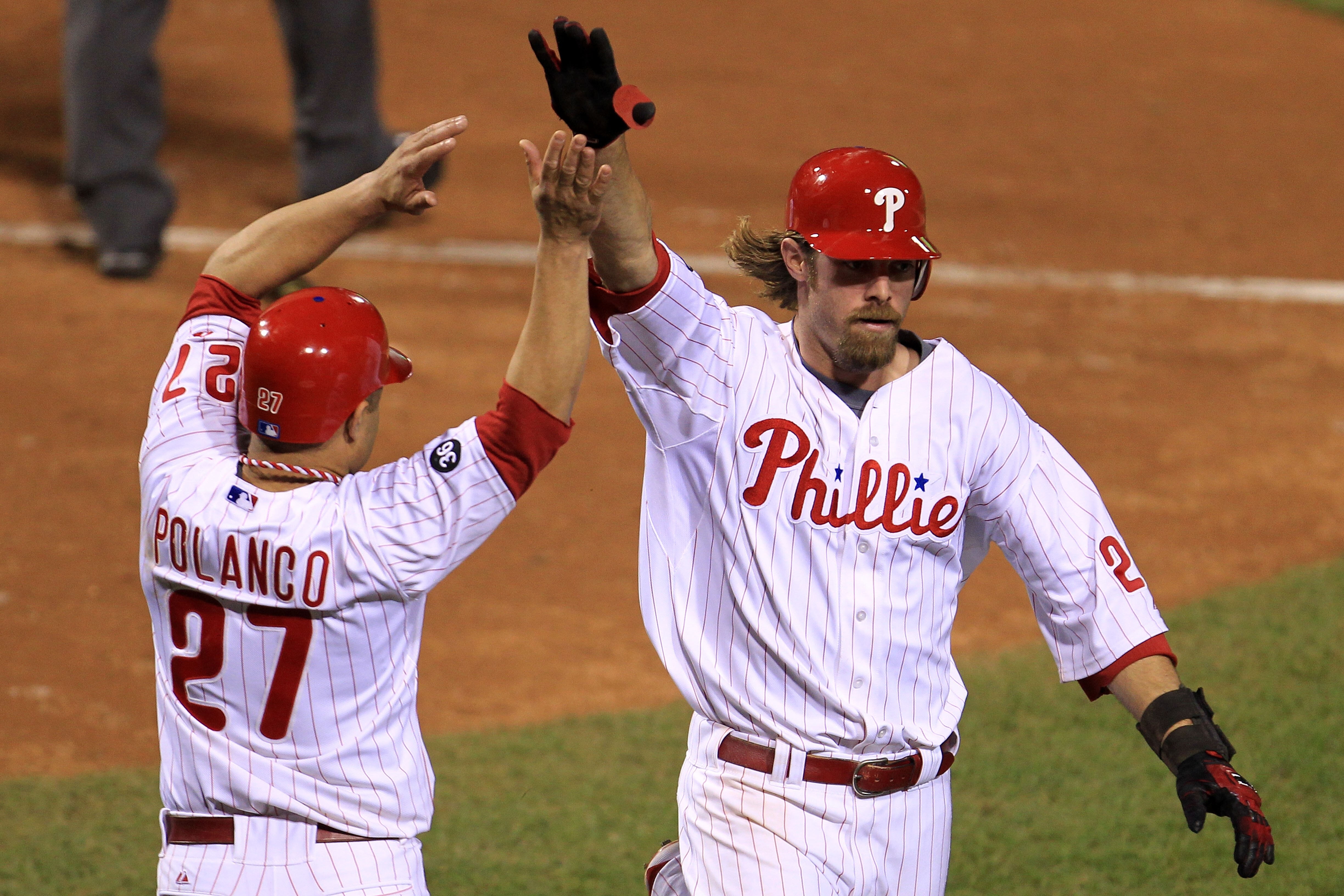 PHILADELPHIA - OCTOBER 17:  Jayson Werth #28 of the Philadelphia Phillies is greeted by Placido Polanco #27 after Werth scores on a three run double by teammate Jimmy Rollins #11 in the seventh inning against the San Francisco Giants in Game Two of the NL