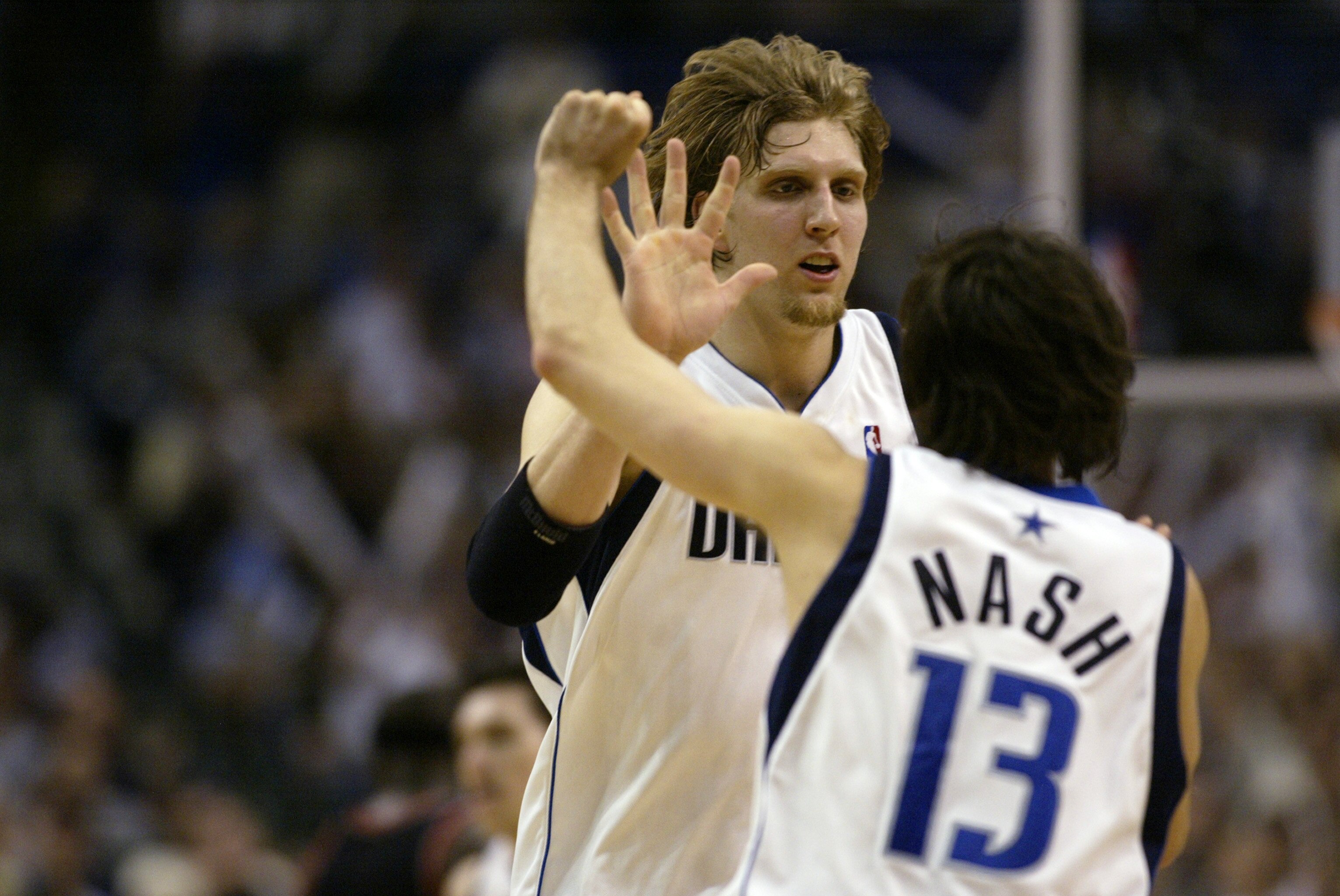 DALLAS - APRIL19:  Dirk Nowitzki #41 of the Dallas Mavericks celebrates with his teammate Steve Nash #13 in Game one of the Western Conference Quarterfinals against the Portland Trail Blazers during the 2003 NBA Playoffs at American Airlines Center on Apr