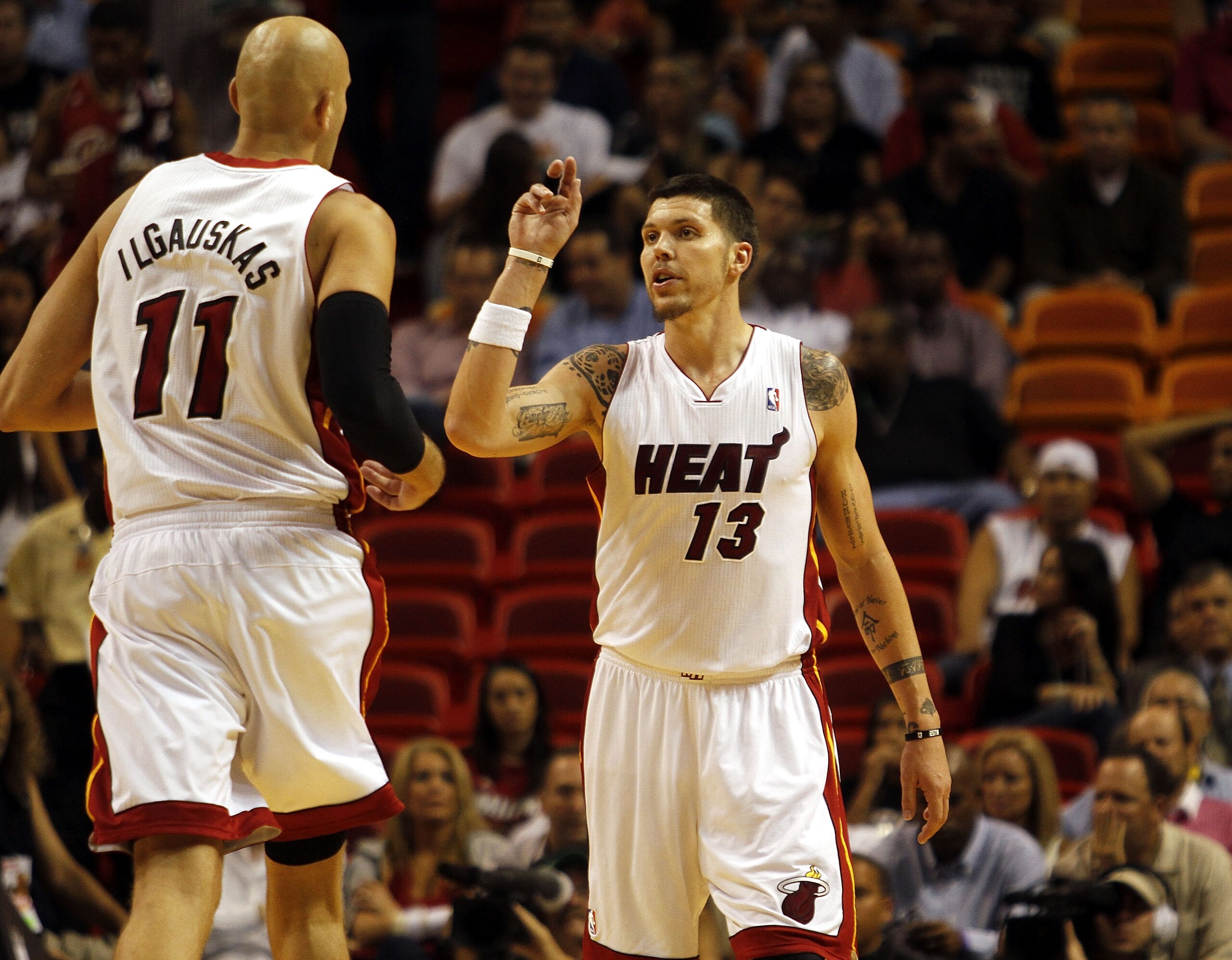 MIAMI - OCTOBER 18:  Center Zydrunas Ilgauskas #11 and Forward Mike Miller #13 of the Miami Heat celebrate against the Charlotte Bobcats on October 18, 2010 at American Airlines Arena in Miami, Florida. NOTE TO USER: User expressly acknowledges and agrees