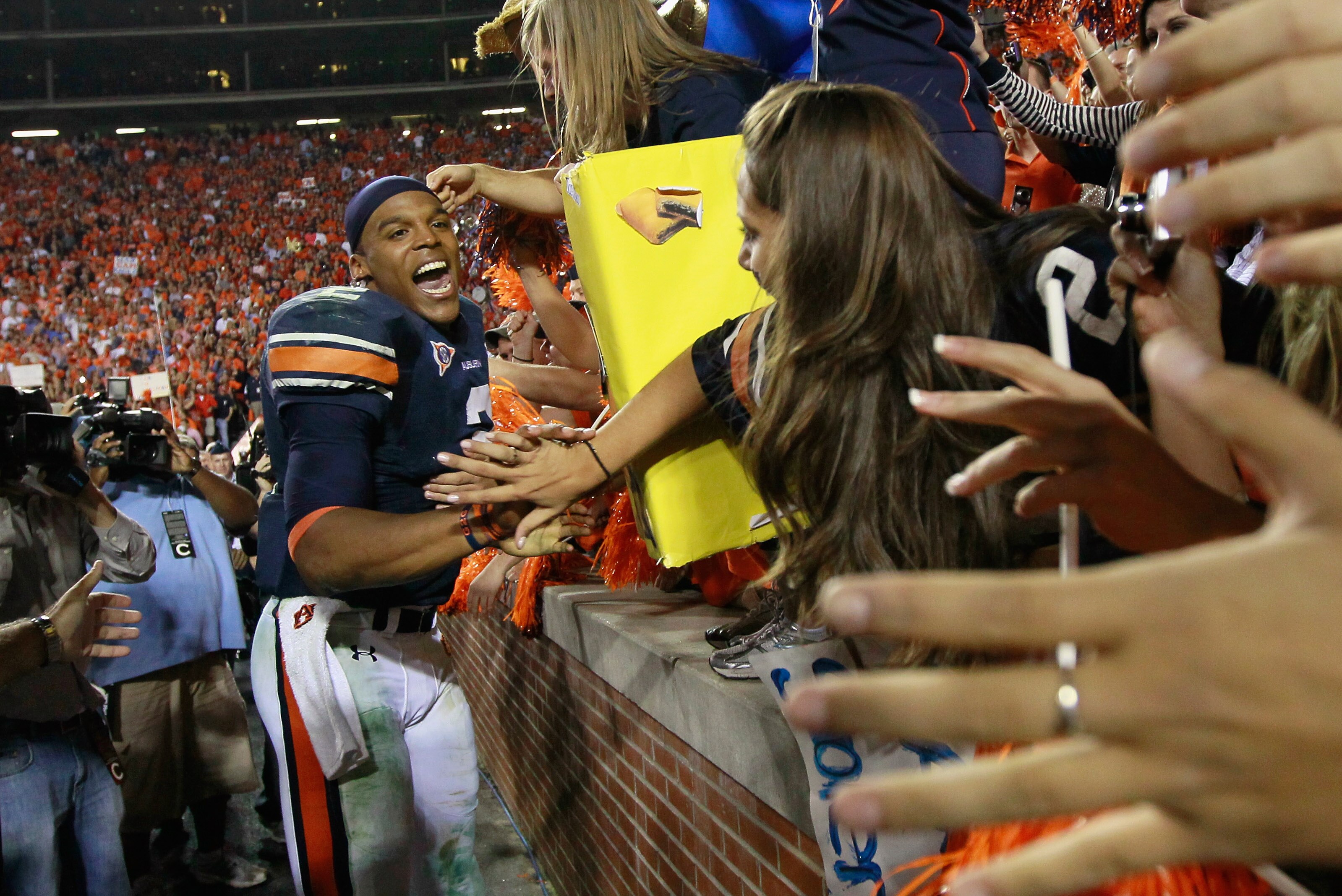AUBURN, AL - NOVEMBER 13:  Quarterback Cameron Newton #2 of the Auburn Tigers celebrates with fans after their 49-31 win over the Georgia Bulldogs at Jordan-Hare Stadium on November 13, 2010 in Auburn, Alabama.  (Photo by Kevin C. Cox/Getty Images)