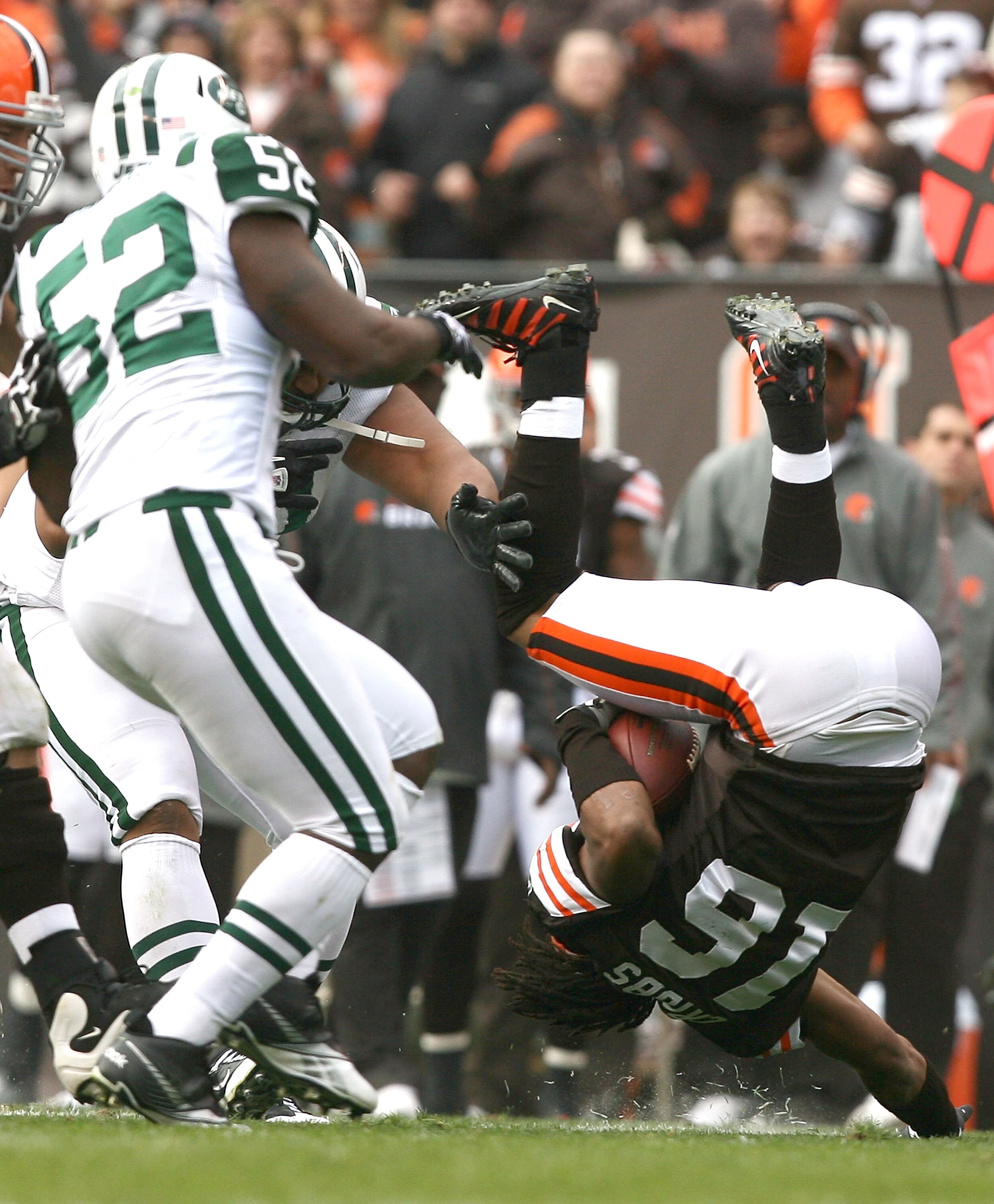 CLEVELAND - NOVEMBER 14:  Wide receiver Joshua Cribbs #16 of the Cleveland Browns flips over as he is hit by linebacker David Harris #52 of the New York Jets at Cleveland Browns Stadium on November 14, 2010 in Cleveland, Ohio.  (Photo by Matt Sullivan/Get