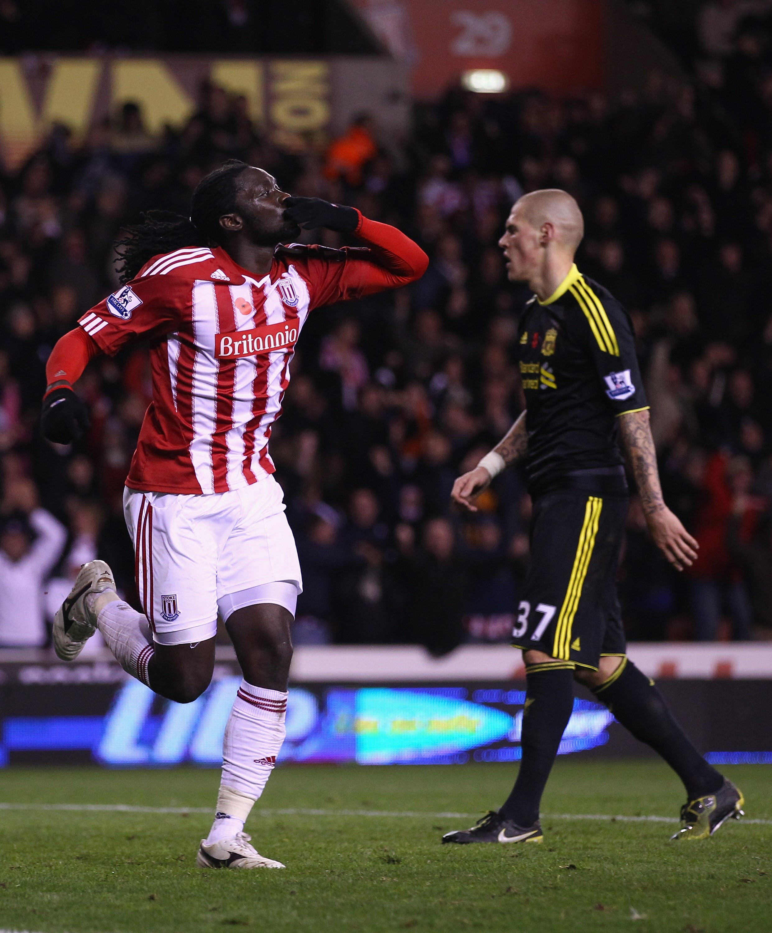 STOKE ON TRENT, ENGLAND - NOVEMBER 13: Kenwyne Jones of Stoke City celebrates after scoring the second goal as Martin Skrtel of Liverpool shows his dejection during the Barclays Premier League match between Stoke City and Liverpool at Britannia Stadium o STOKE ON TRENT, ENGLAND - NOVEMBER 13: Kenwyne Jones of Stoke City celebrates after scoring the second goal as Martin Skrtel of Liverpool shows his dejection during the Barclays Premier League match between Stoke City and Liverpool at Britannia Stadium o