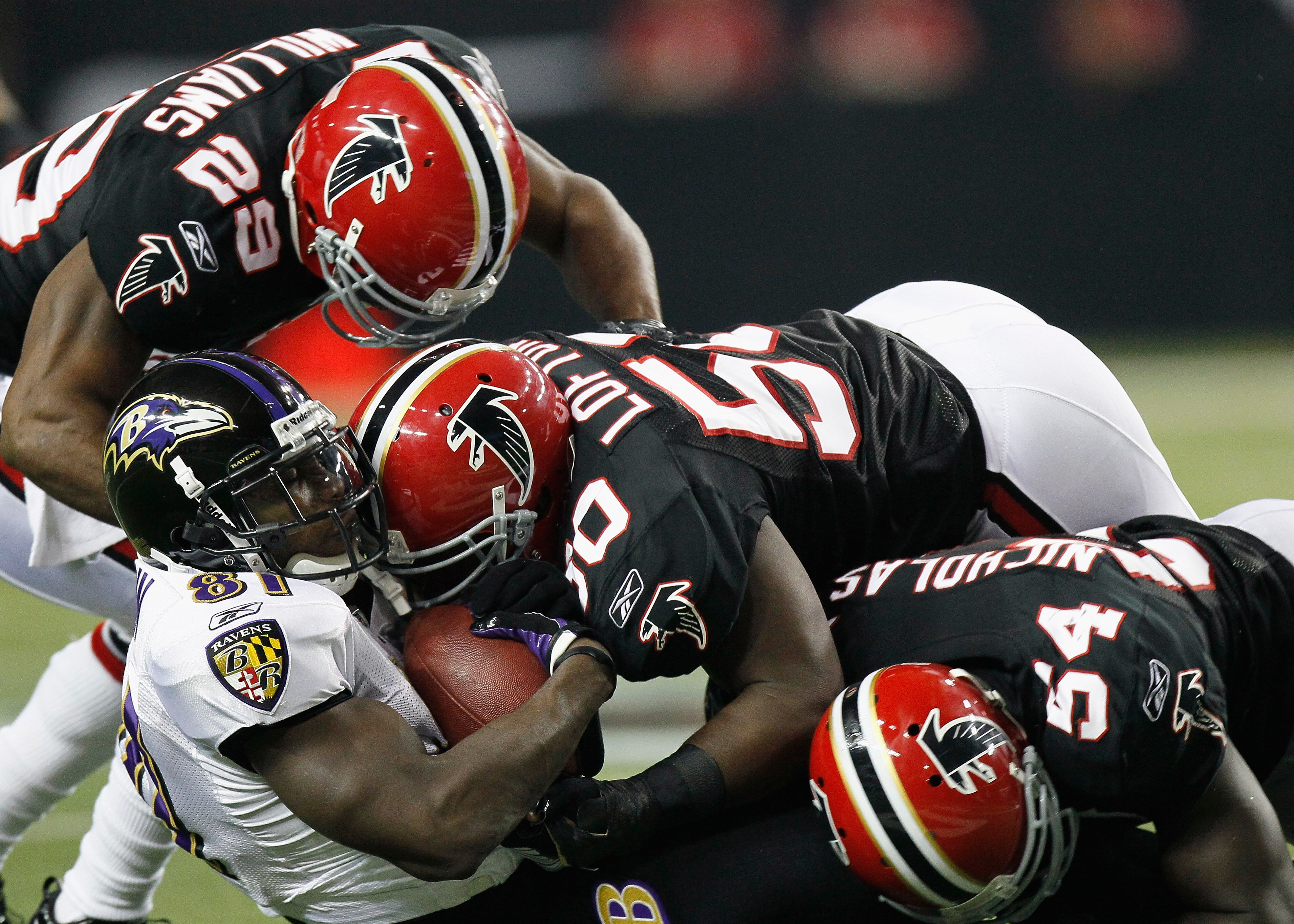 ATLANTA - NOVEMBER 11:   Brian Williams #29, Curtis Lofton #50 and Stephen Nicholas #54 of the Atlanta Falcons tackle Anquan Boldin #81 of the Baltimore Ravens at Georgia Dome on November 11, 2010 in Atlanta, Georgia.  (Photo by Kevin C. Cox/Getty Images)