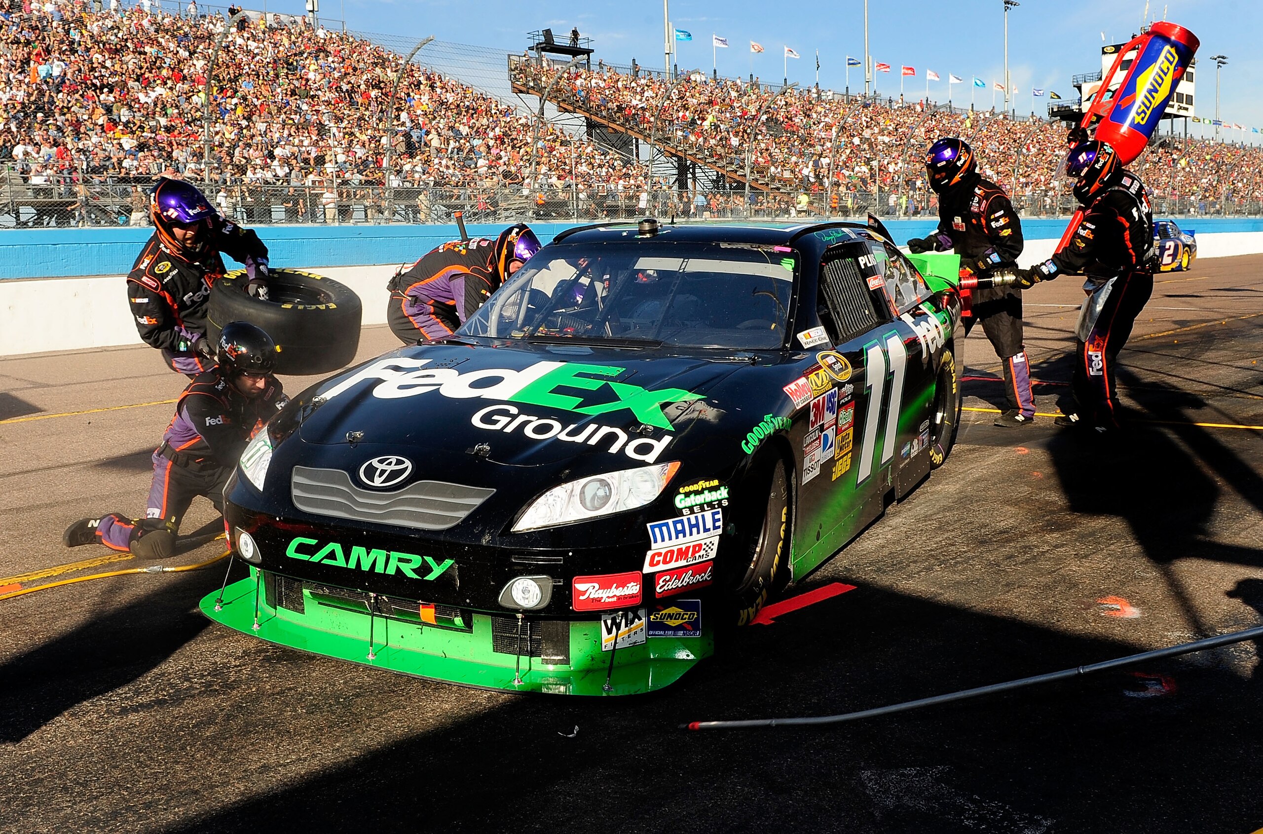 AVONDALE, AZ - NOVEMBER 14: Denny Hamlin, driver of the #11 FedEx Toyota, makes a pit stop during the NASCAR Sprint Cup Series Kobalt Tools 500 at Phoenix International Raceway on November 14, 2010 in Avondale, Arizona. (Photo by Rusty Jarrett/Getty Ima AVONDALE, AZ - NOVEMBER 14: Denny Hamlin, driver of the #11 FedEx Toyota, makes a pit stop during the NASCAR Sprint Cup Series Kobalt Tools 500 at Phoenix International Raceway on November 14, 2010 in Avondale, Arizona. (Photo by Rusty Jarrett/Getty Ima