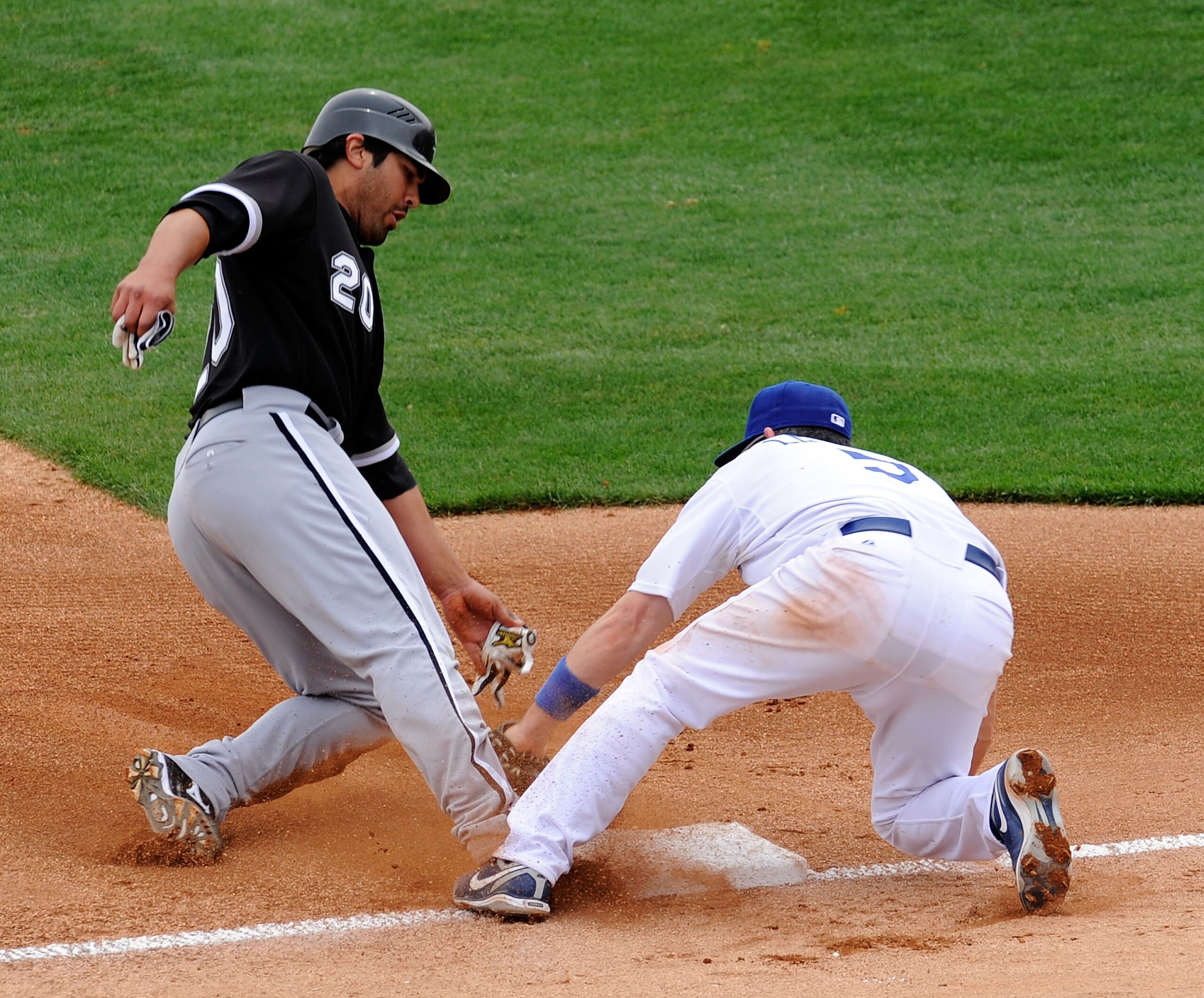 GLENDALE, AZ - MARCH 05:  Carlos Quinten #20 of the Chicago White Sox steals thrid base as Mark Loretta #5 of the Los Angeles Dodgers puts on the tag  during a spring trainning game at Camelback Ranch on March 5, 2009, in Glendale, Arizona. (Photo by Kevo