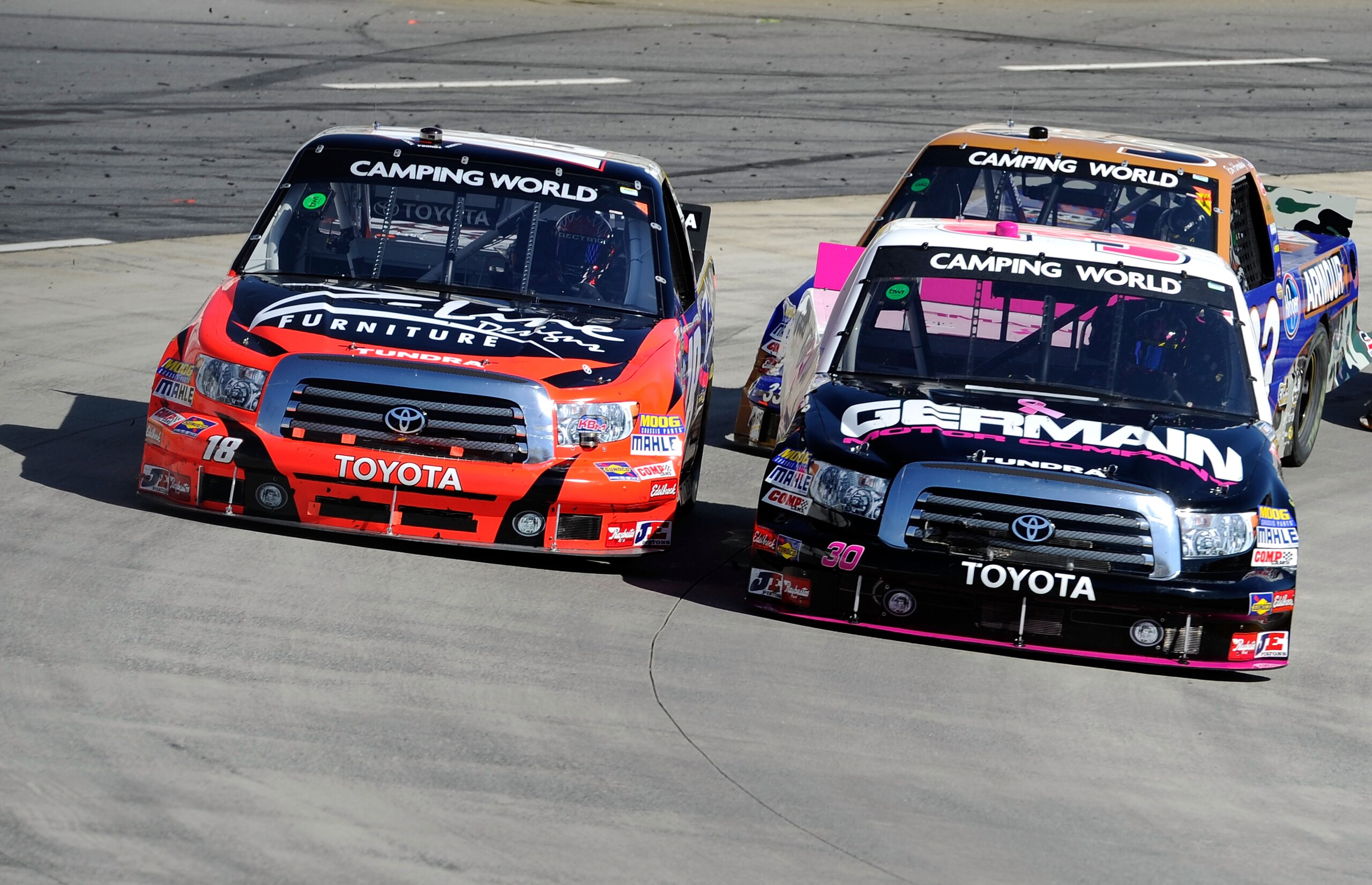 MARTINSVILLE, VA - OCTOBER 23:  Kyle Busch, driver of the #18 Tundra/Z-Line Designs Toyota, races Todd Bodine, driver of the #30 Germain.com Toyota, side by side during the NASCAR Camping World Truck Series Kroger 200 at Martinsville Speedway on October 2