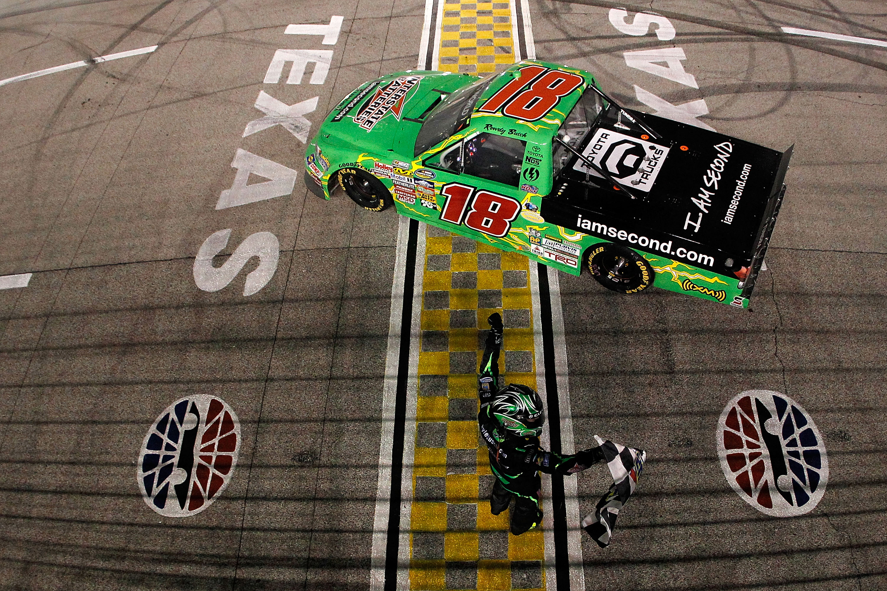 FORT WORTH, TX - NOVEMBER 05:  Kyle Busch, driver of the #18 Interstate Batteries/Iamsecond.com Toyota, celebrates on track after winning the NASCAR Camping World Truck Series WinStar World Casino 350k at Texas Motor Speedway on November 5, 2010 in Fort W