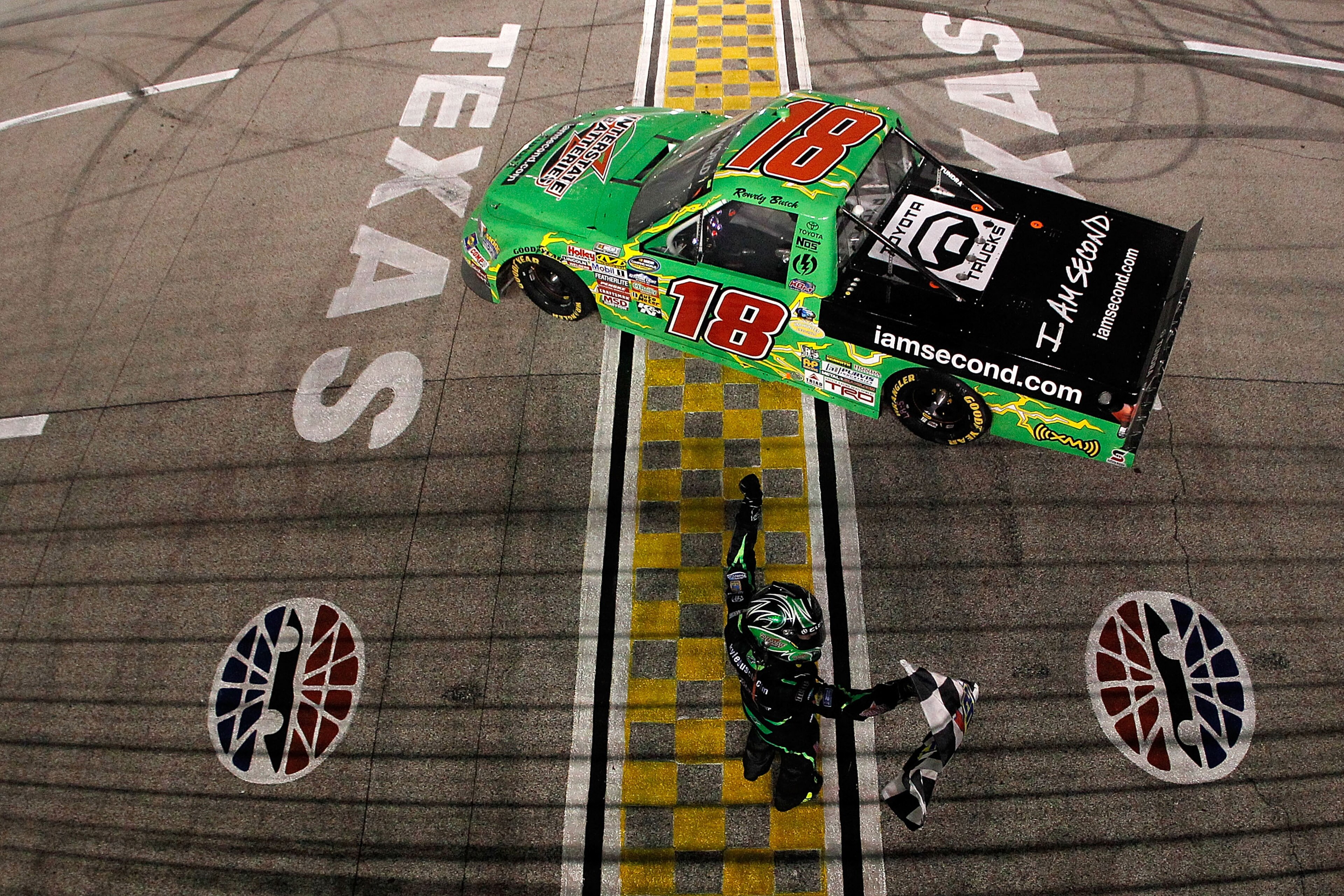 FORT WORTH, TX - NOVEMBER 05:  Kyle Busch, driver of the #18 Interstate Batteries/Iamsecond.com Toyota, celebrates on track after winning the NASCAR Camping World Truck Series WinStar World Casino 350k at Texas Motor Speedway on November 5, 2010 in Fort W
